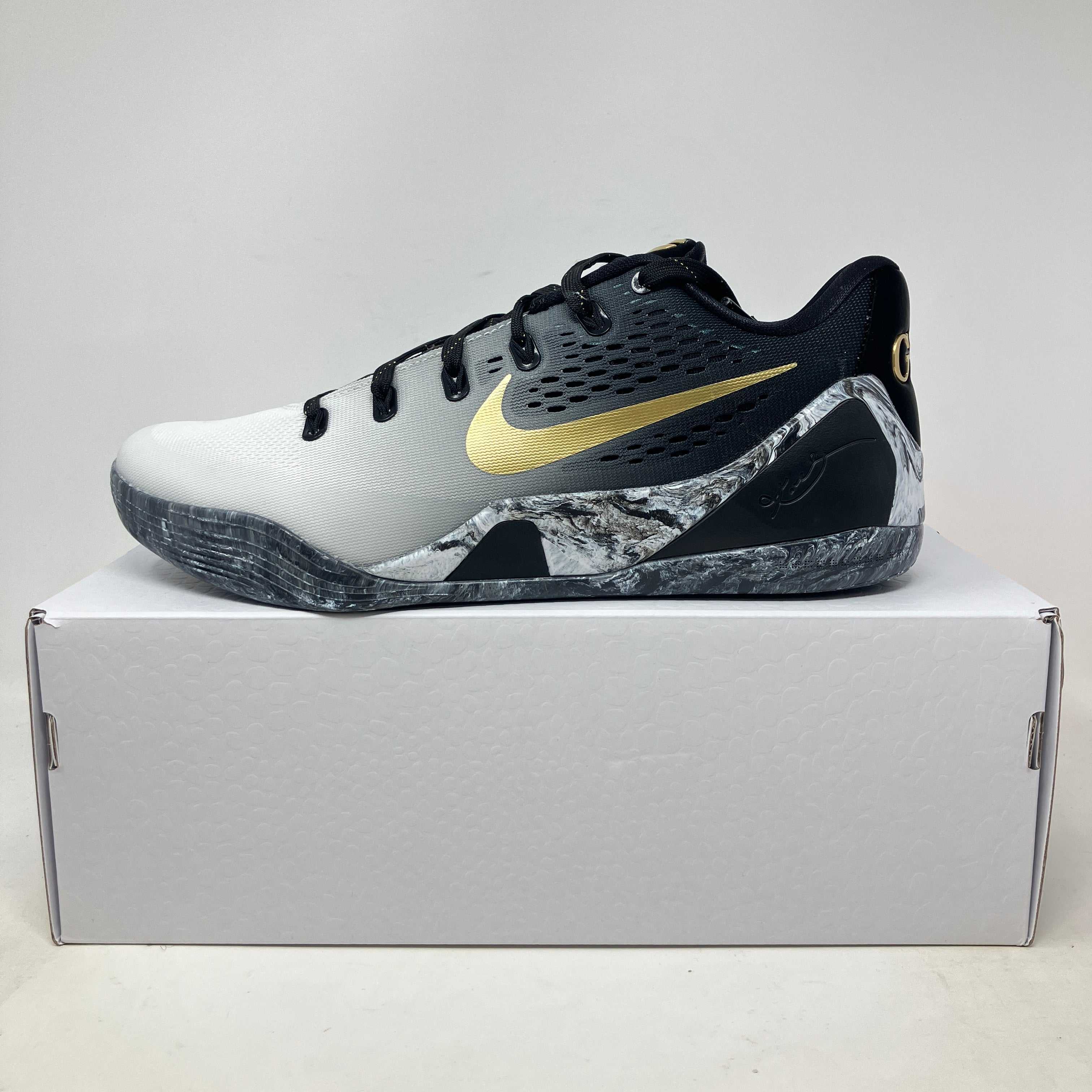 Nike Kobe 9 EM Low Protro Mambacita sneaker, brand new with box, showcasing black and white colorway with gold accents.