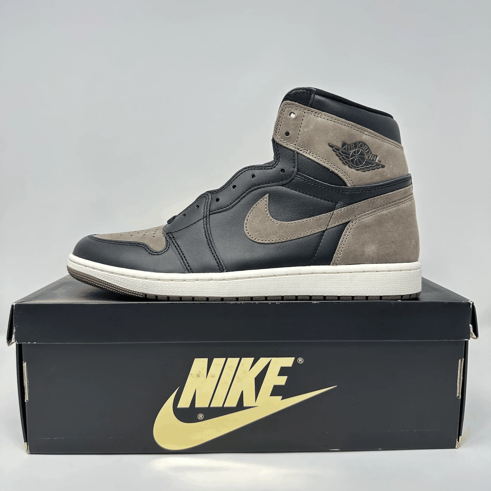 Jordan 1 Retro High OG Palomino sneaker in black and tan on Nike box, brand new with all accessories.