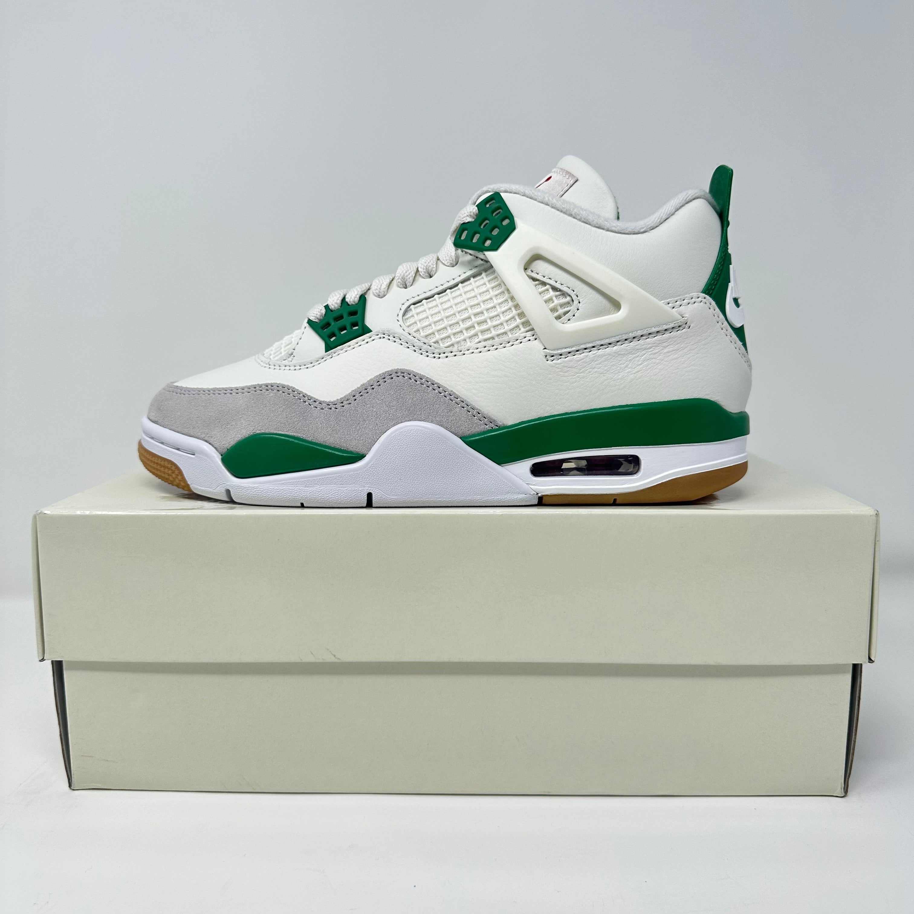Jordan 4 Retro SB Pine Green sneakers on box, brand new with all accessories.