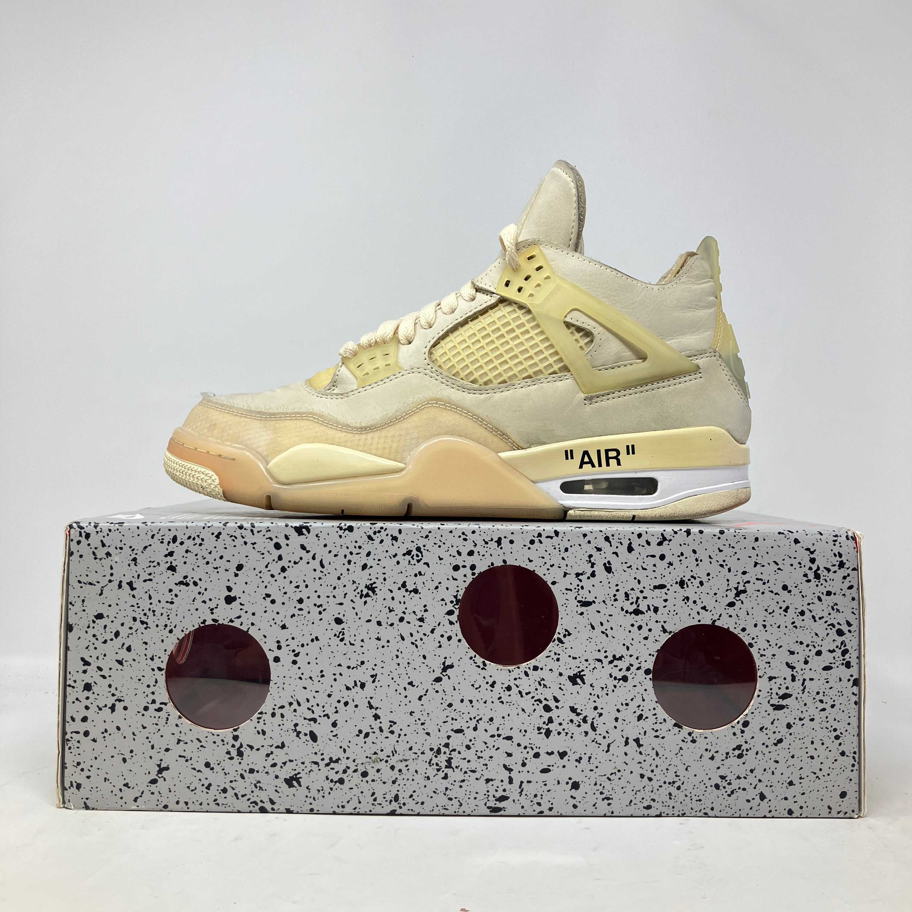 Pre-owned Jordan 4 Retro Off-White Sail women's sneaker on gray speckled box without lid and mint laces.