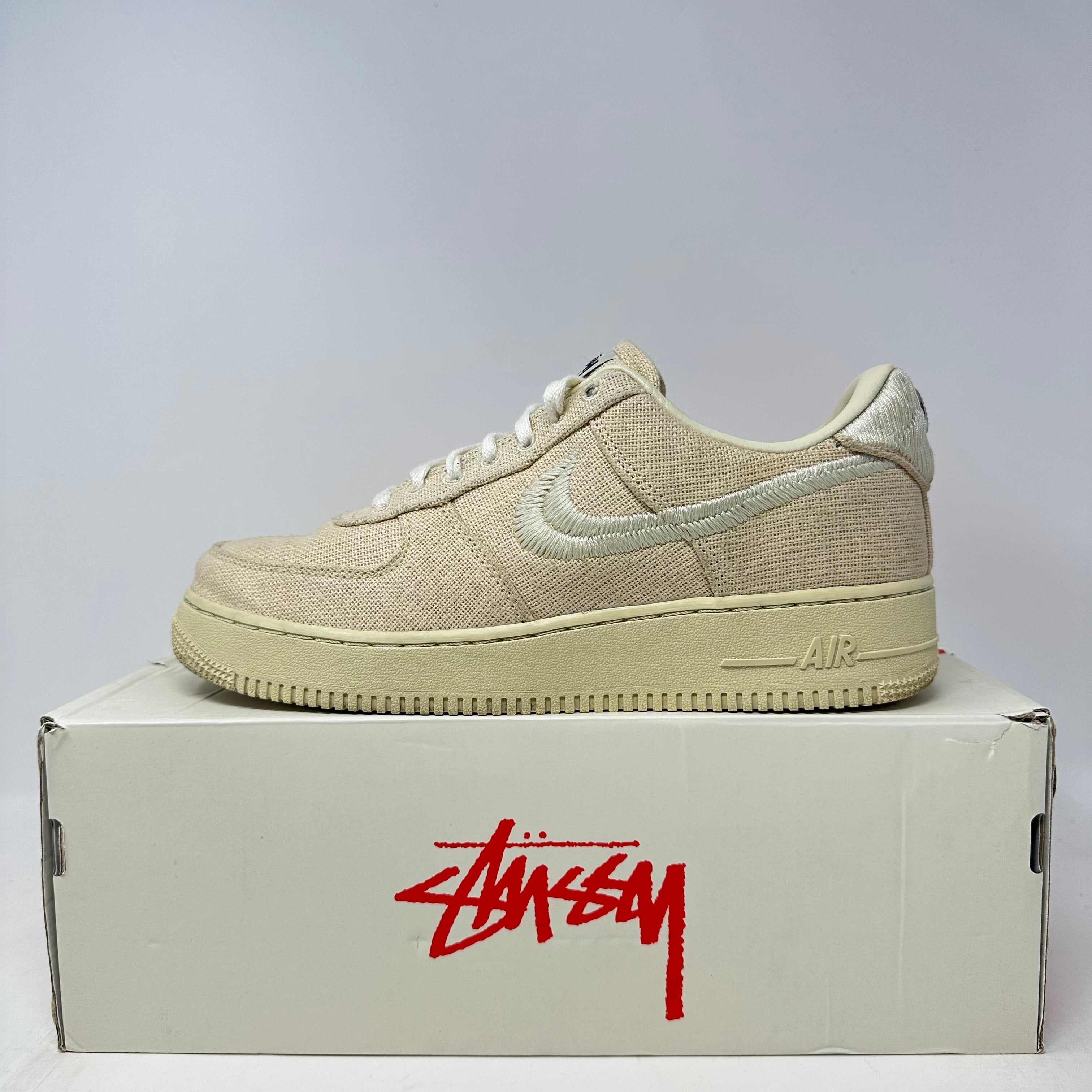 Nike Air Force 1 Low Stussy Fossil beige sneaker on box, pre-owned with accessories included