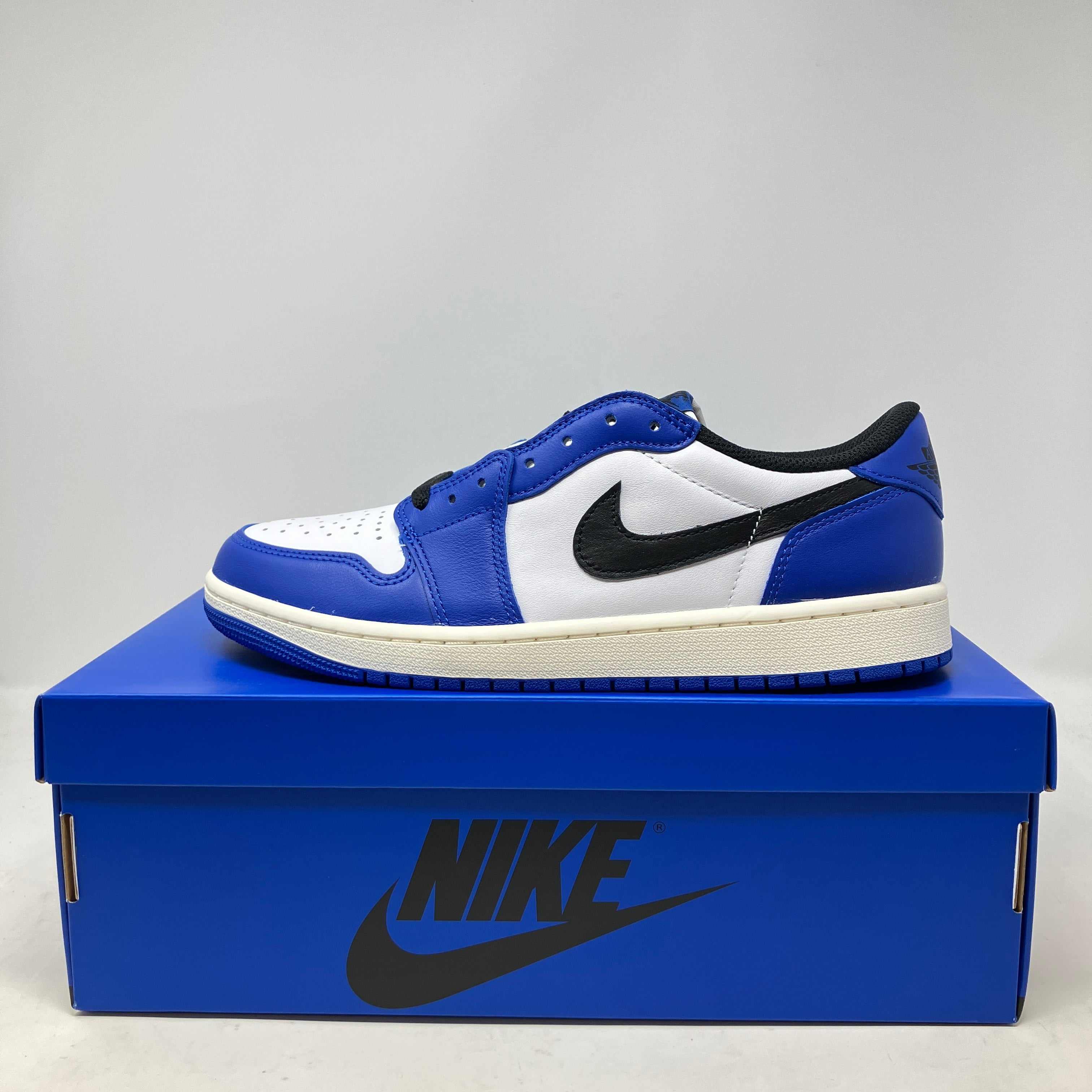 Jordan 1 Retro Low OG Game Royal sneaker in blue and white on a blue Nike box, brand new condition