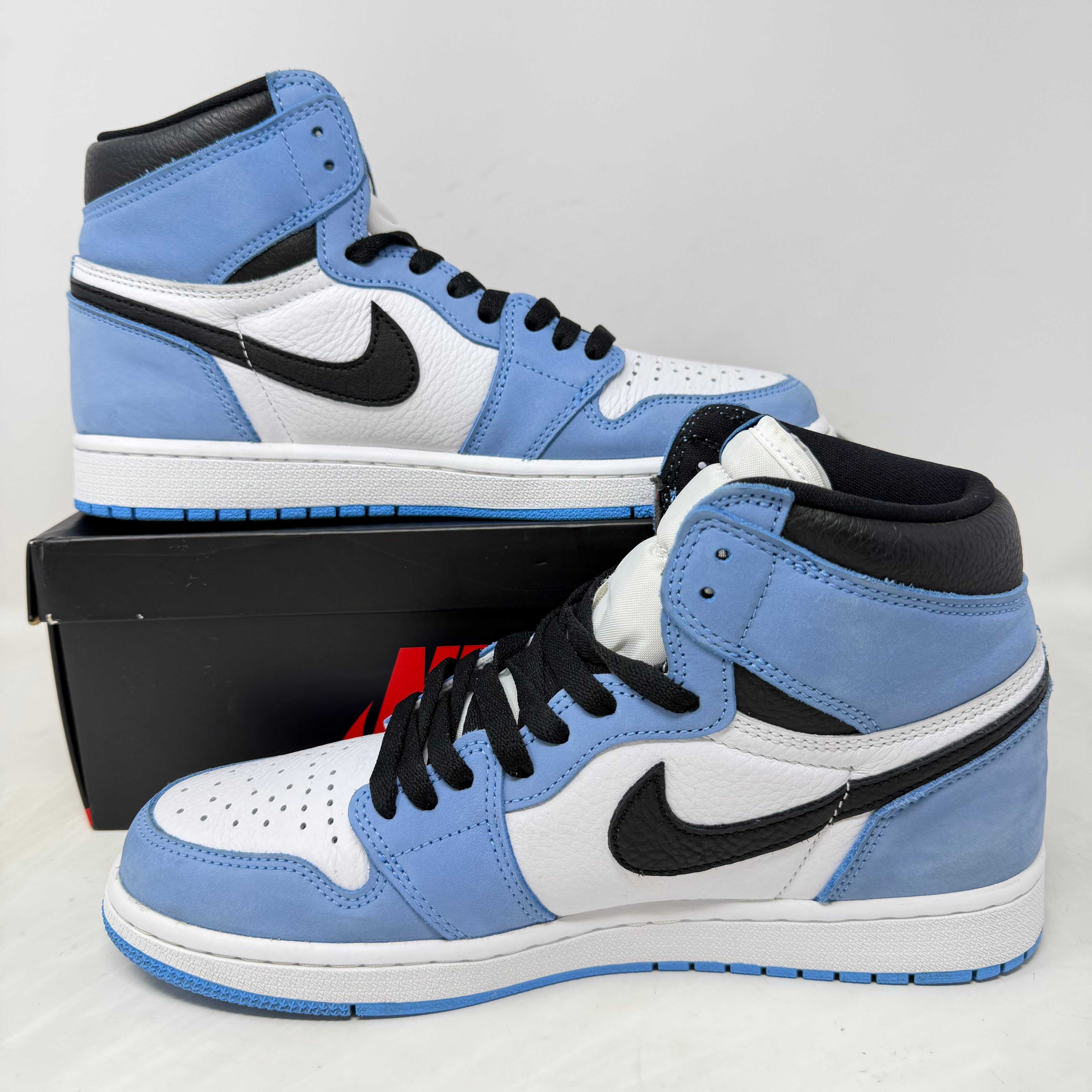 Blue and white Nike Air Jordan 1 sneakers with black swoosh on black Nike box for Black Friday & Cyber Monday sneaker sale at Hidden Realm OC