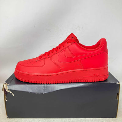 Nike Air Force 1 Low sneaker in vivid red leather, with tonal Swoosh, perforated toe, and matching rubber sole.