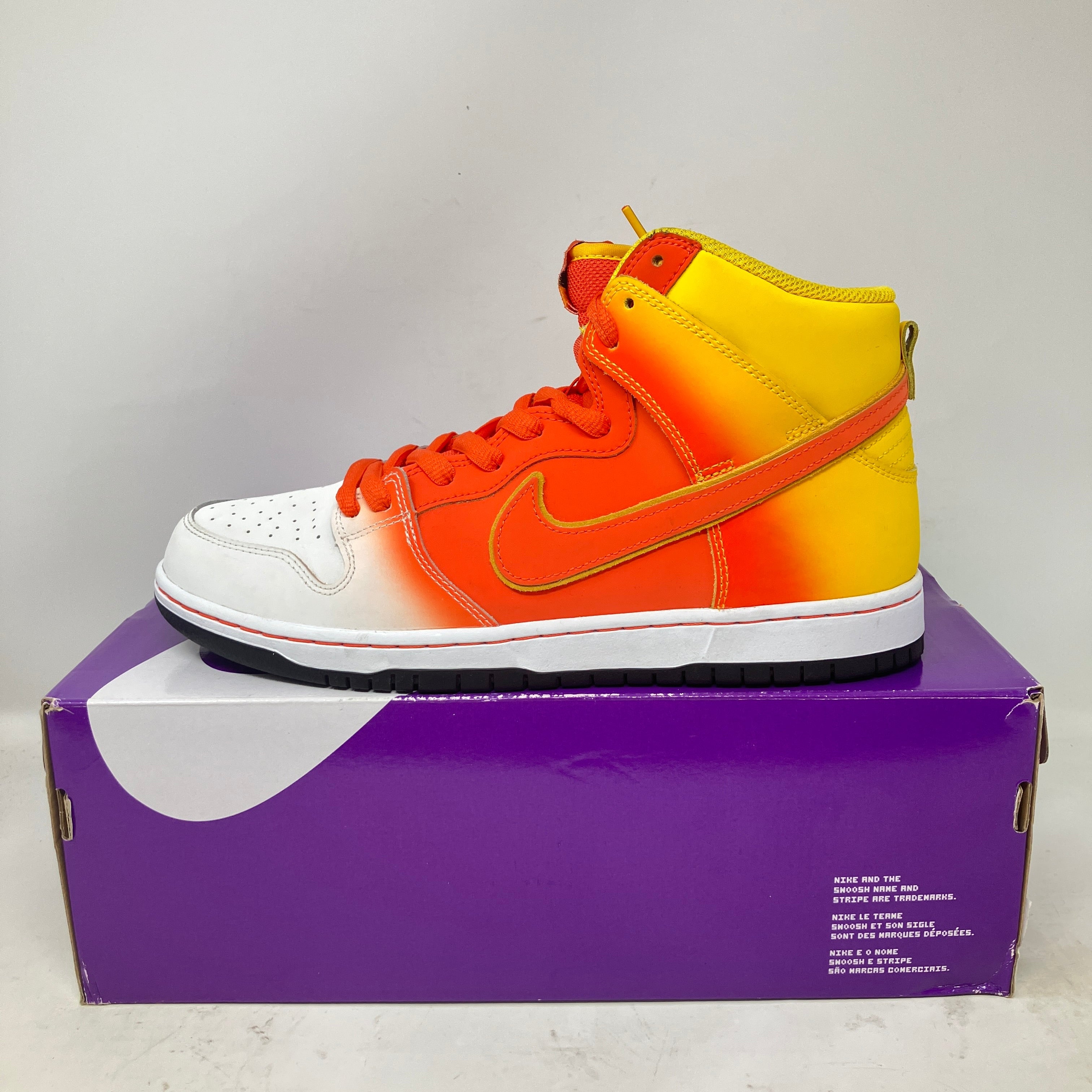 Nike SB Dunk High Sweet Tooth Candy Corn sneaker in orange, yellow, and white on purple box