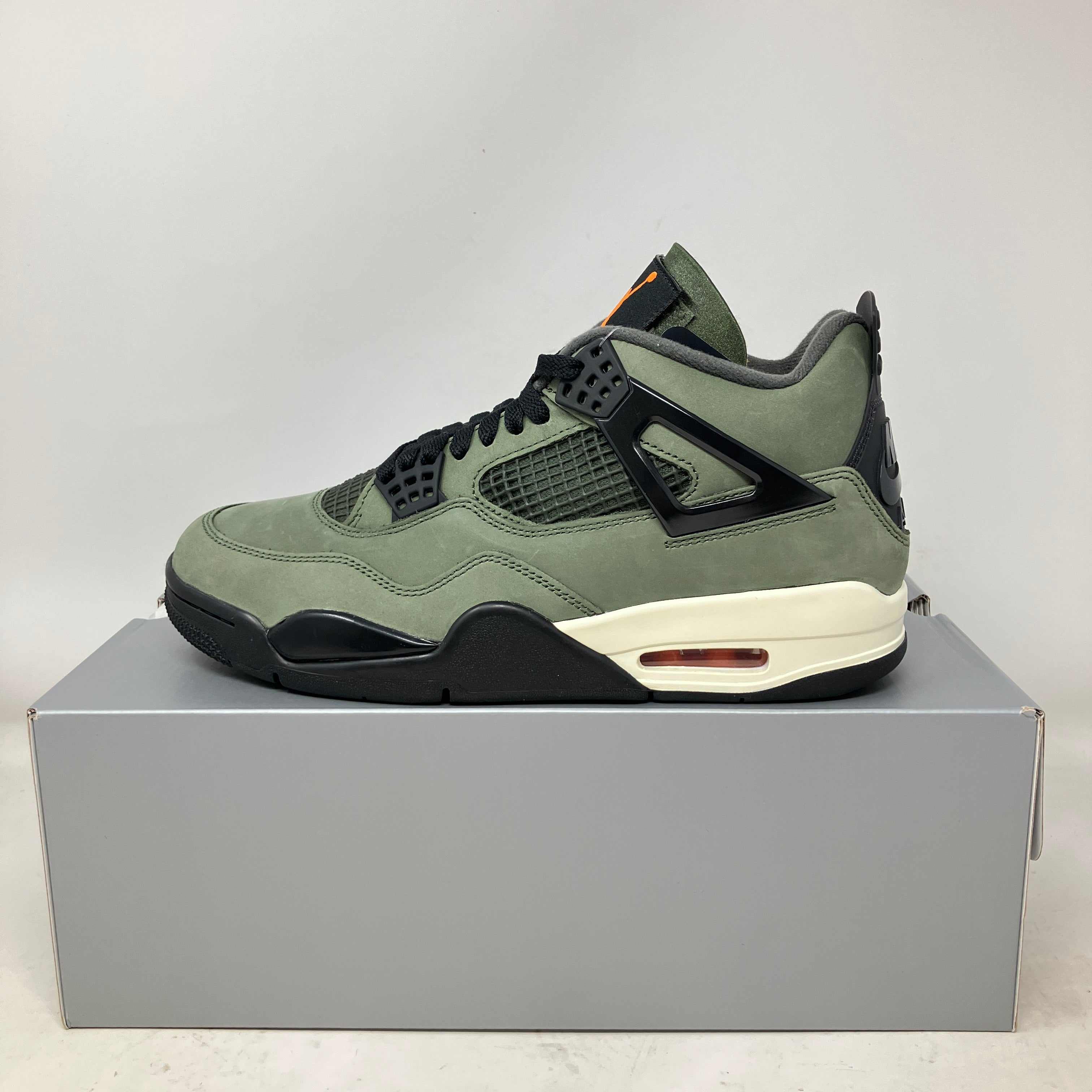 Jordan 4 Retro OG SP Undefeated sneaker in green and black, brand new with all accessories on gray box