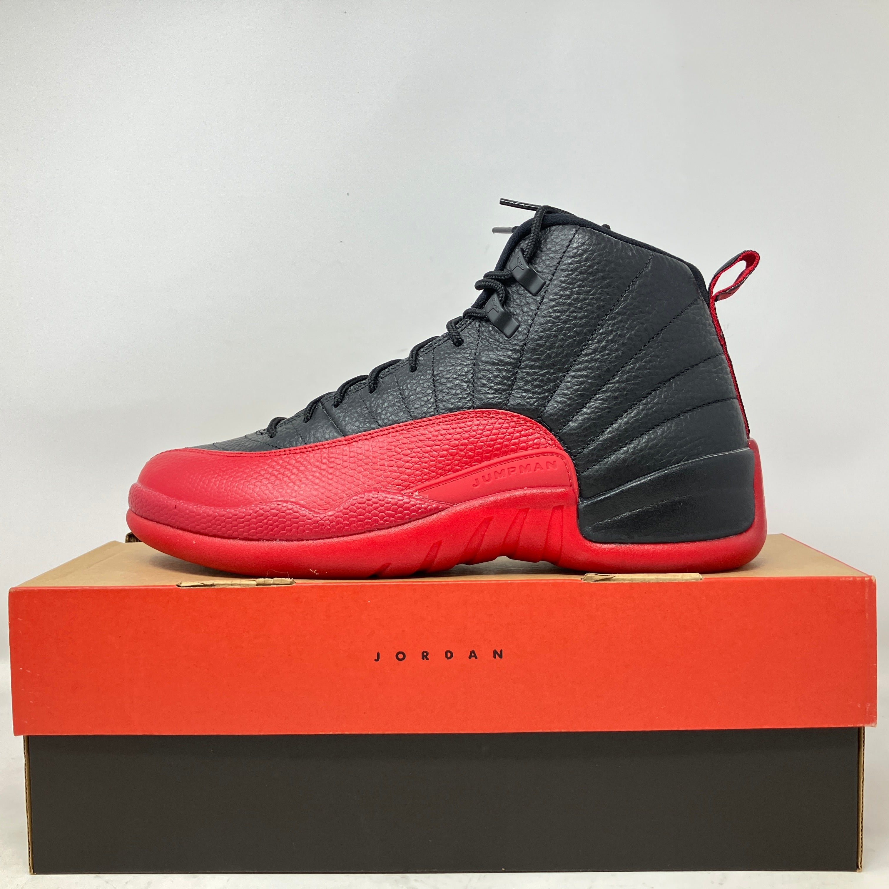Jordan 12 Retro Flu Game sneaker in black and red, brand new with all accessories on box