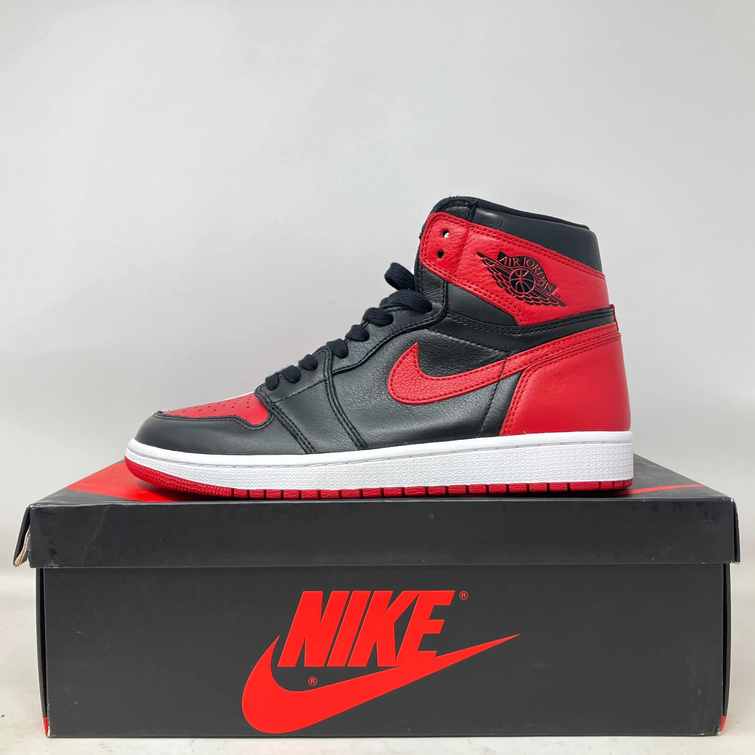 Jordan 1 Retro High Homage To Home Chicago sneaker in black and red on Nike box, brand new with all accessories.
