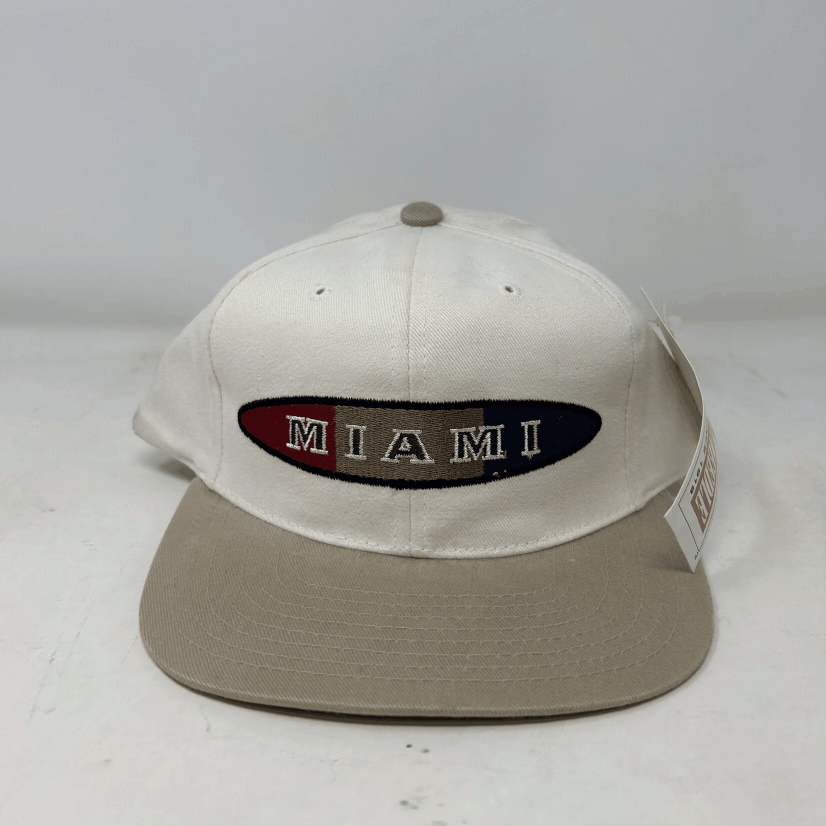 Vintage Miami Hurricanes American Needle snapback hat in beige and white, brand new condition