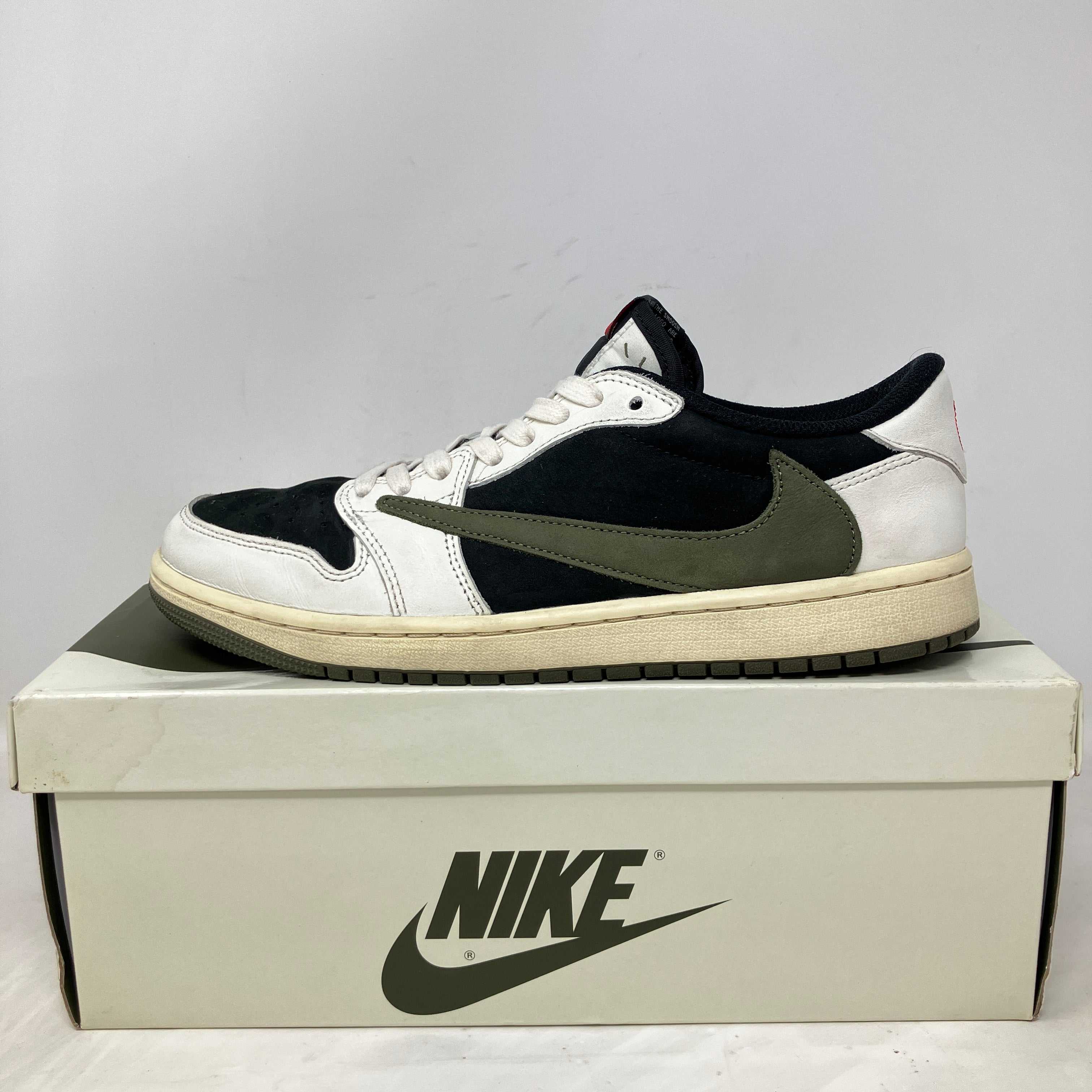 Jordan 1 Retro Low OG SP Travis Scott Olive Women’s sneaker on Nike box, pre-owned with accessories included