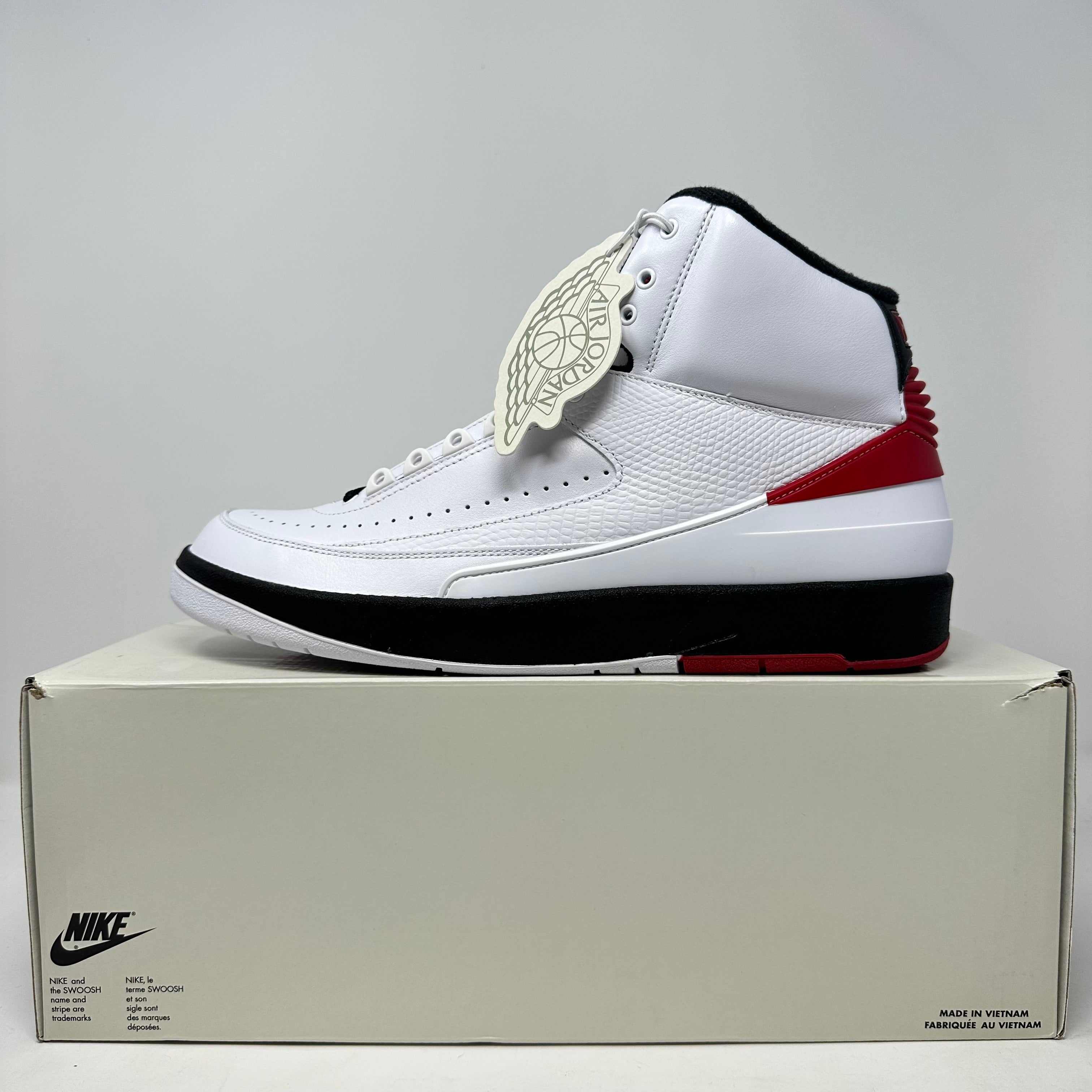Jordan 2 Retro OG Chicago 2022 white, black, and red sneaker on box, brand new with all accessories