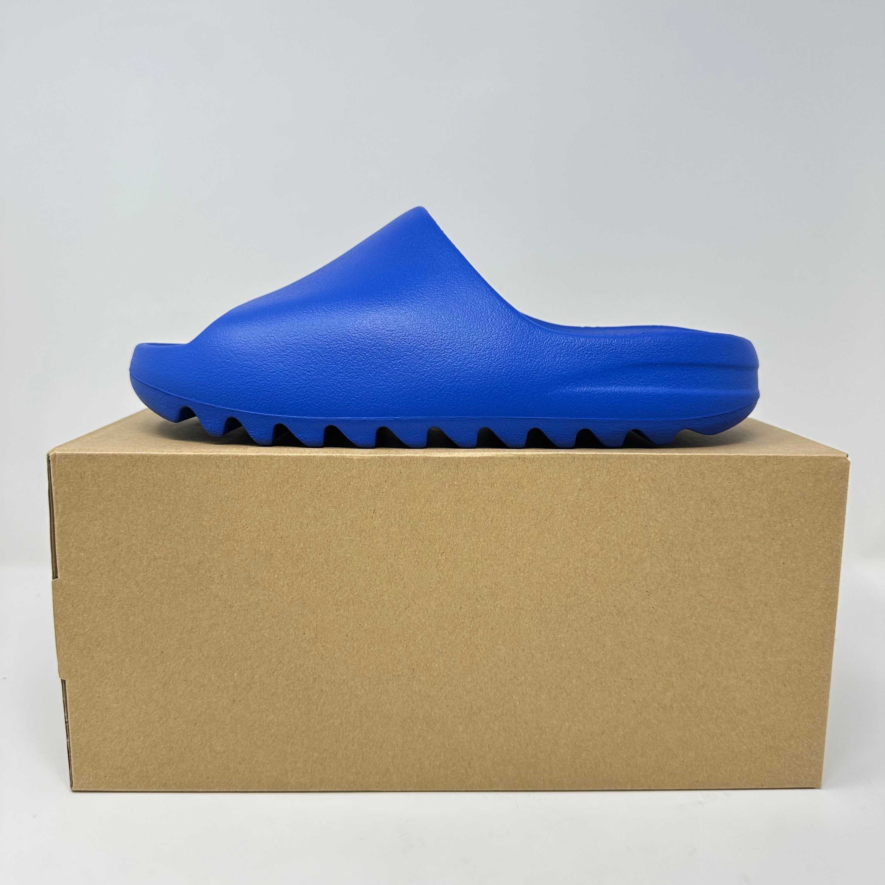 adidas Yeezy Slide Azure in brand new condition displayed on a cardboard box