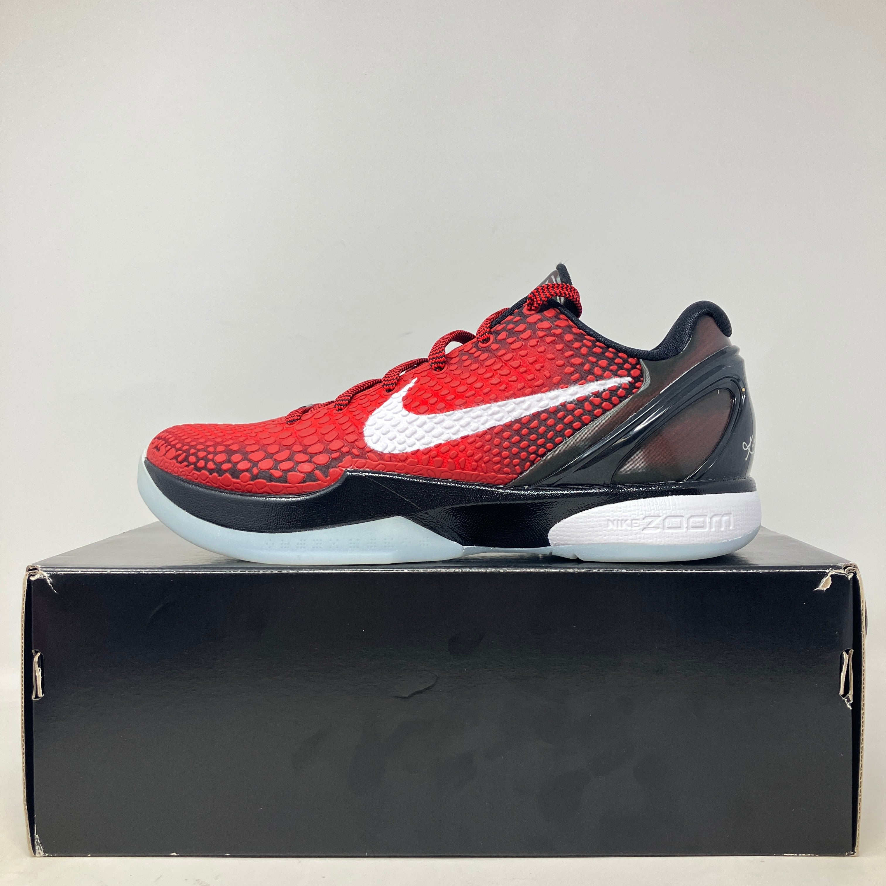 Nike Kobe 6 Protro Challenge Red All-Star basketball shoe on black box, brand new with accessories included