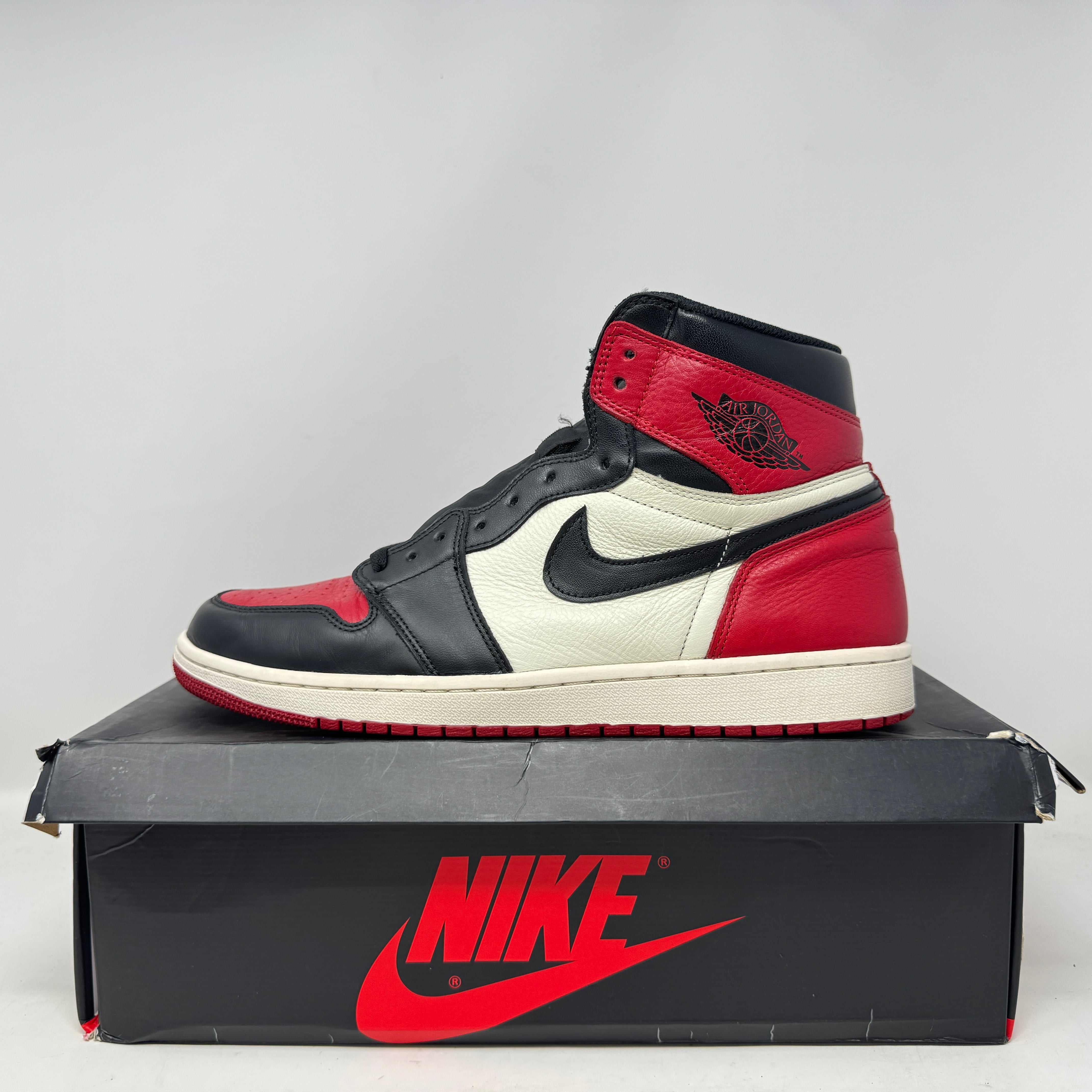 Preowned Jordan 1 Retro High Bred Toe sneaker with original accessories on Nike box