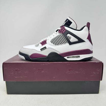 White and purple Jordan 4 Retro PSG Paris Saint-Germain sneaker on box, pre-owned condition