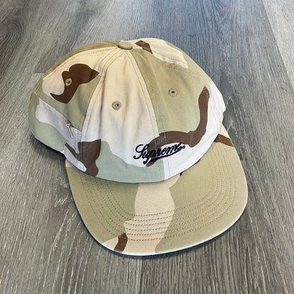 Supreme Side Pocket desert camo 6-panel cap with script logo, pre-owned condition