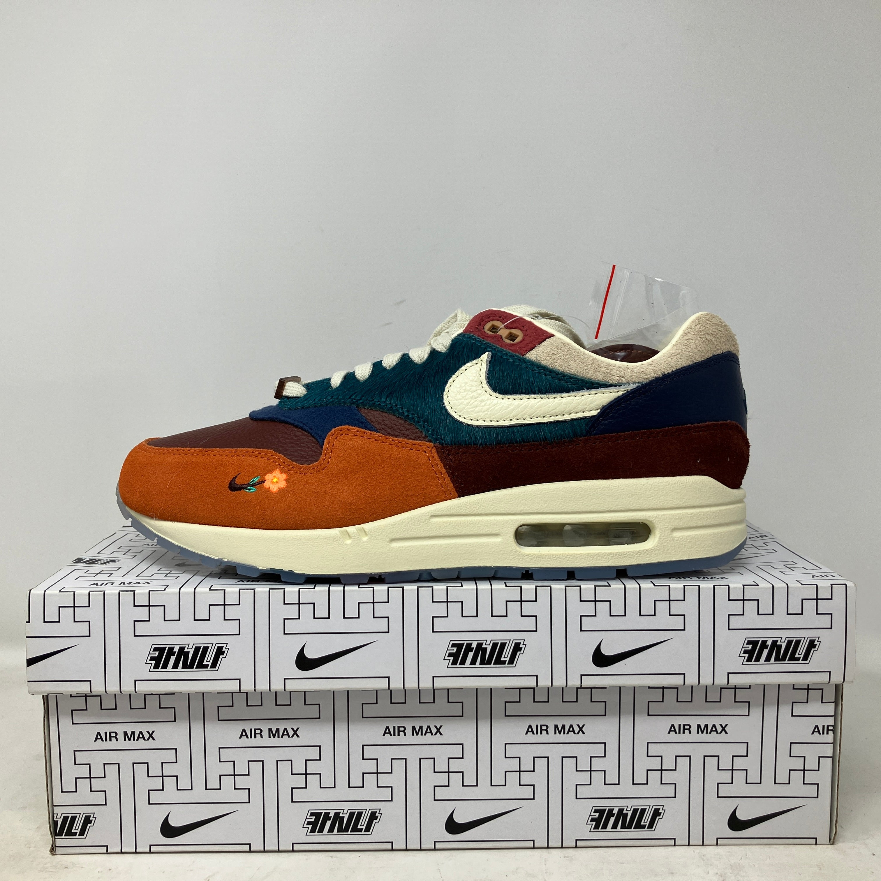 Nike Air Max 1 Kasina Won-Ang Orange sneaker side view on branded box, brand new condition