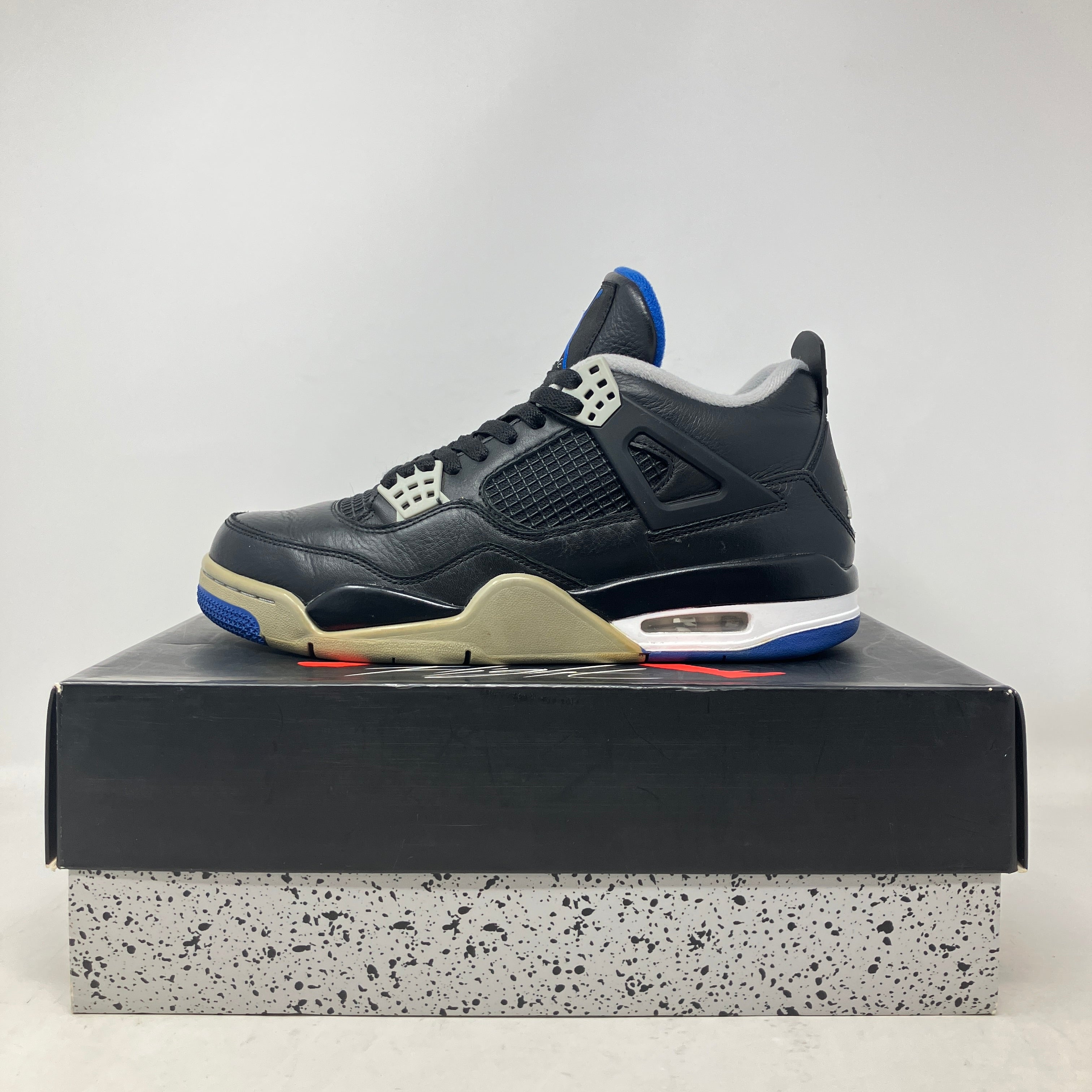 Jordan 4 Retro Motorsports Alternate pre-owned sneakers on box, black and blue design.