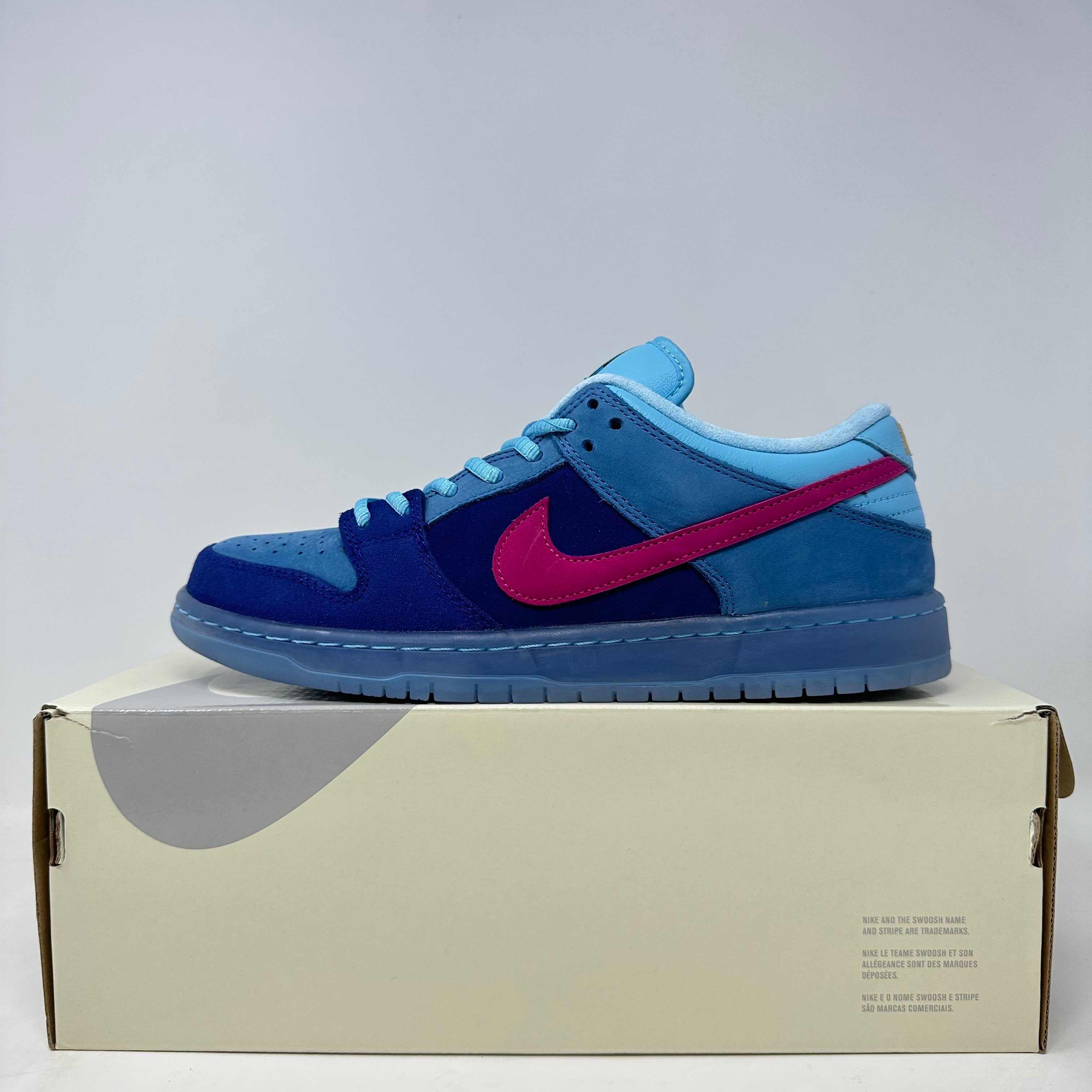 Nike SB Dunk Low Run The Jewels sneaker in blue tones with pink swoosh on shoebox