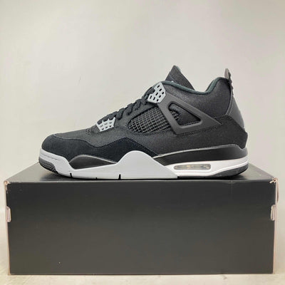Jordan 4 Retro SE black canvas sneaker with grey and white accents, mesh side panels, and visible air sole unit.