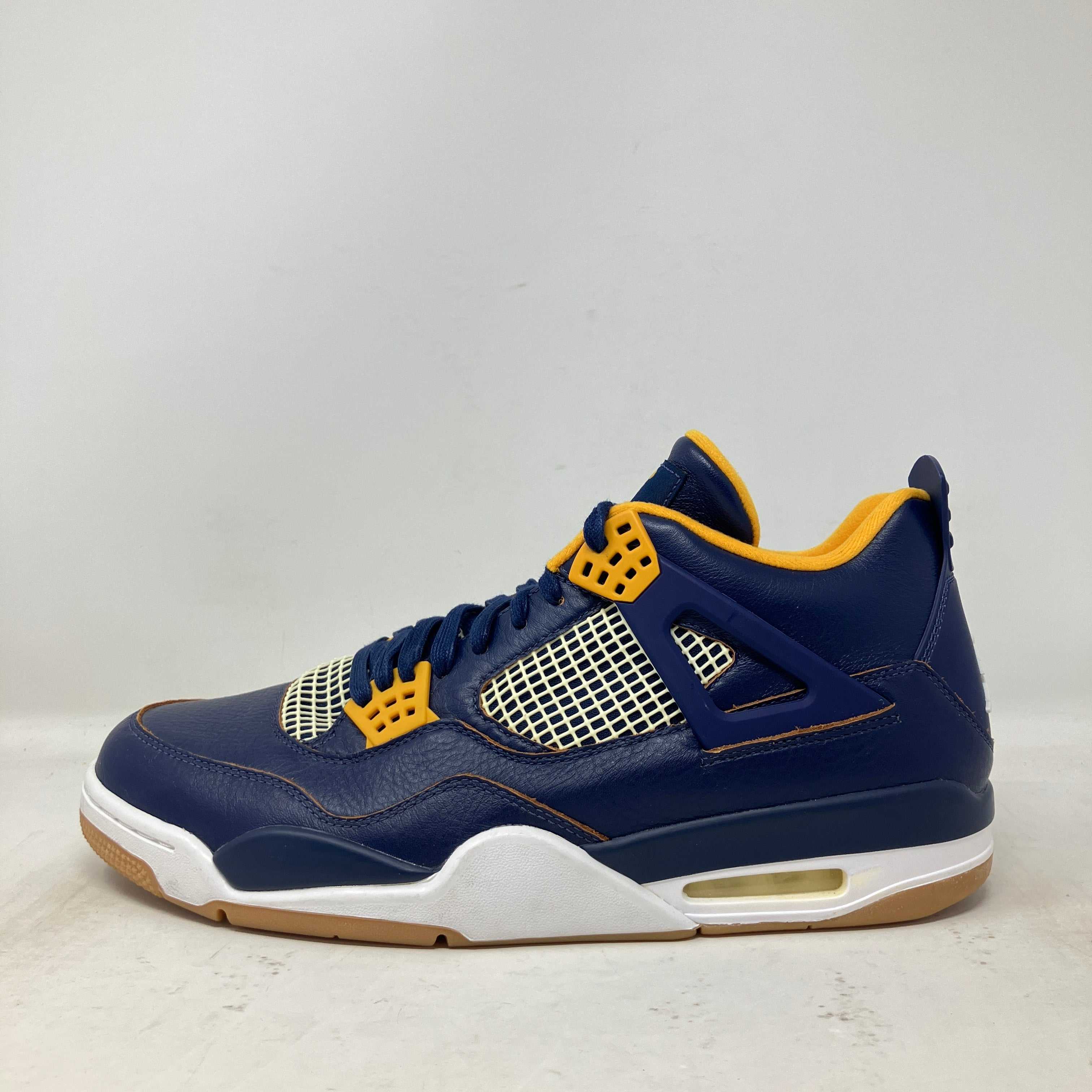 Jordan 4 Retro sneaker in navy blue and yellow viewed from the side, brand new without box