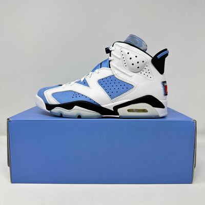 Jordan 6 Retro sneaker in white leather with Carolina blue and black accents, perforated panels and a visible Air unit.