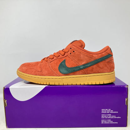 Nike SB Dunk Low Burnt Sunrise sneaker in burnt orange suede with green swoosh on purple box