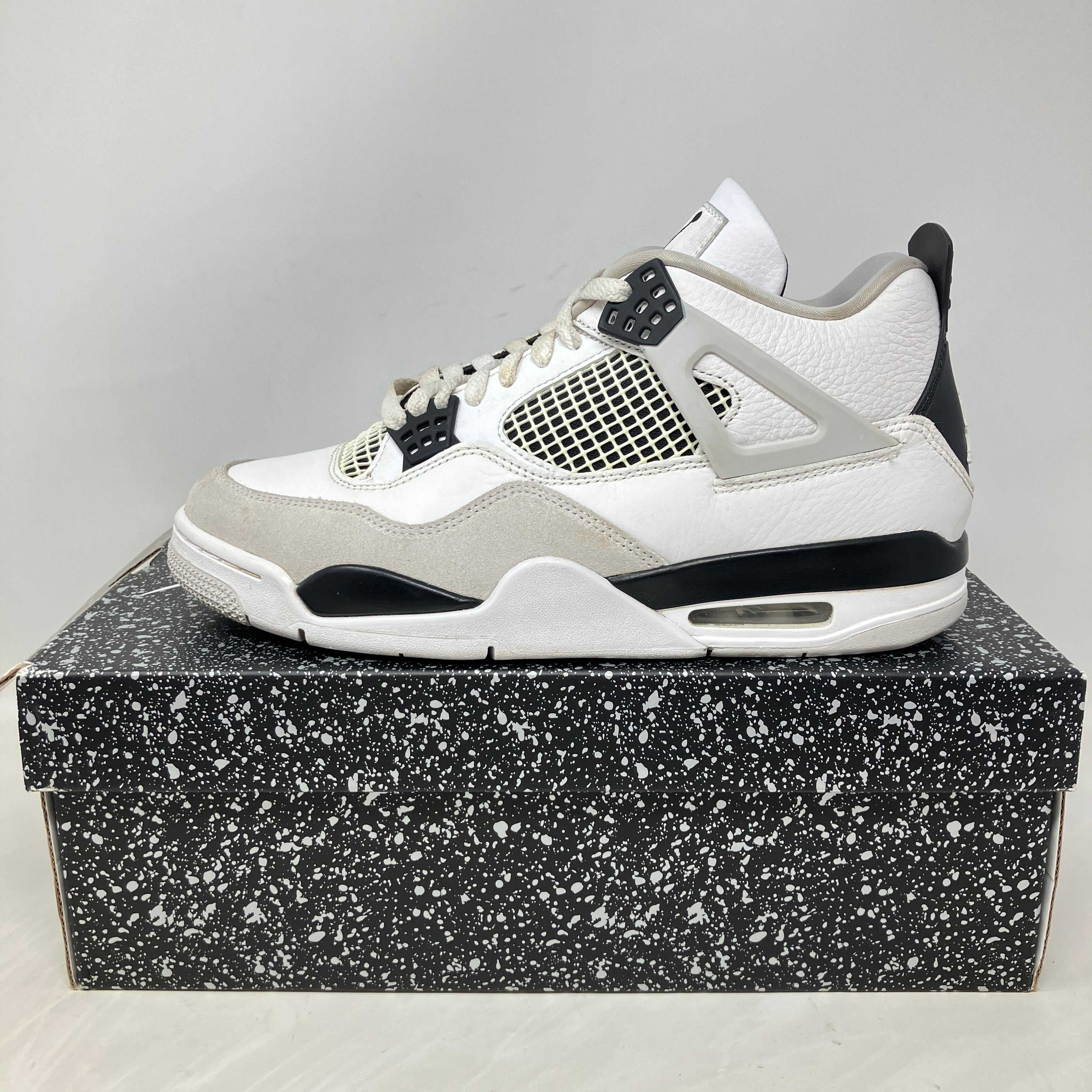 Jordan 4 Retro Military Black pre-owned sneaker on speckled box with all accessories included