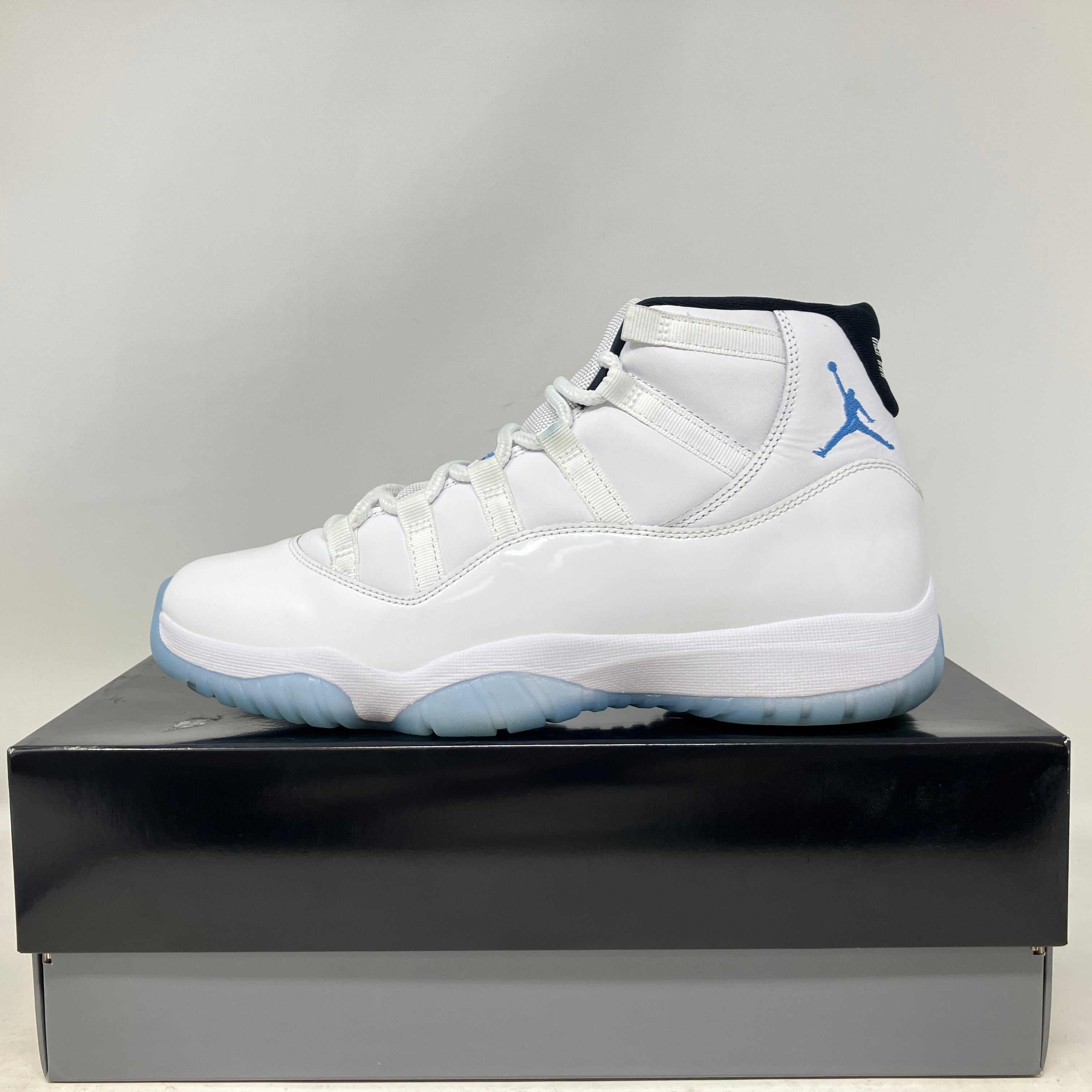 White and blue Jordan 11 Retro Legend Blue sneaker on box, pre-owned condition with all accessories included