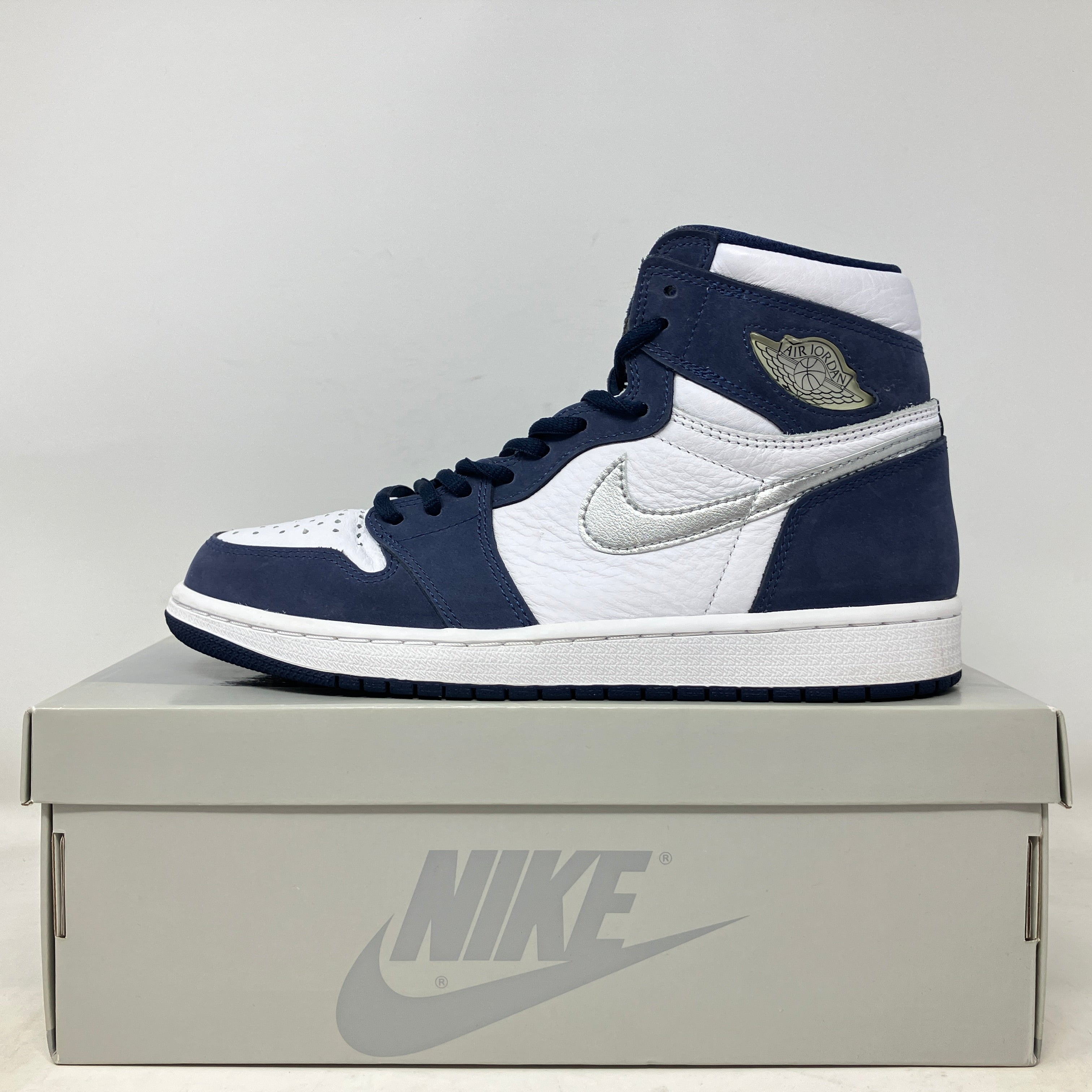 Jordan 1 Retro High CO.JP Midnight Navy 2020 sneaker in white and navy on Nike box, pre-owned with all accessories.