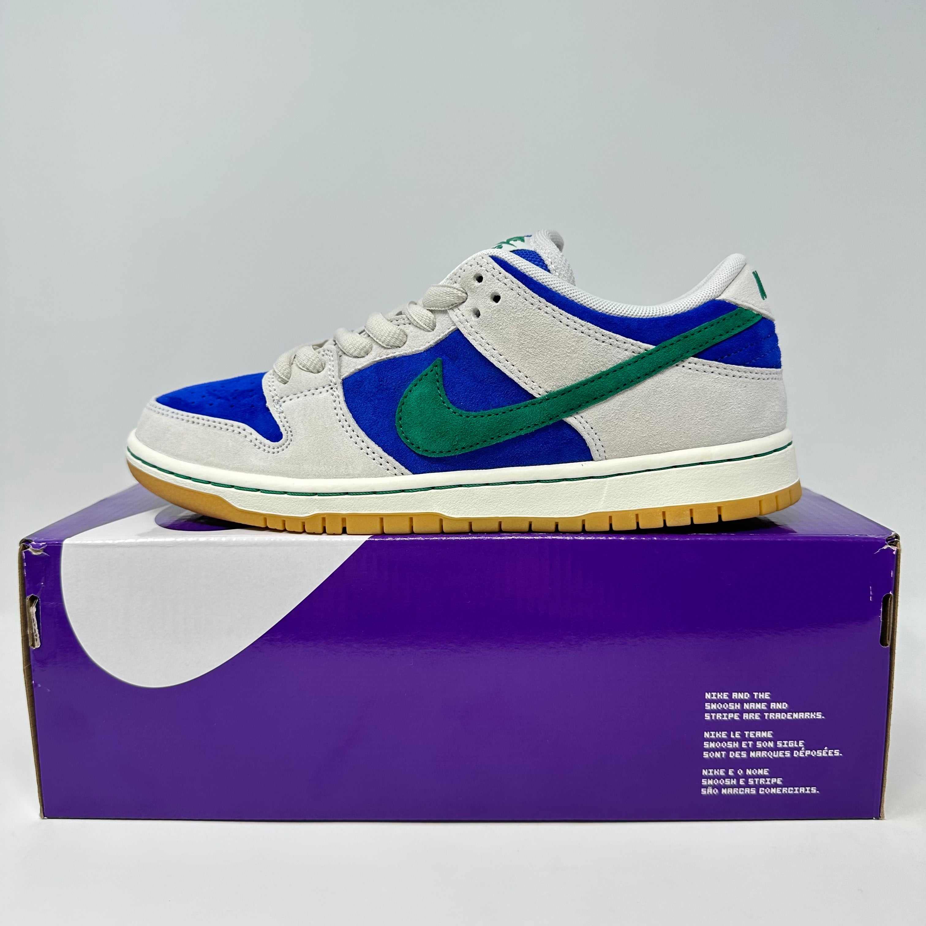 Nike SB Dunk Low Hyper Royal Malachite sneaker in white, blue, and green on purple Nike box