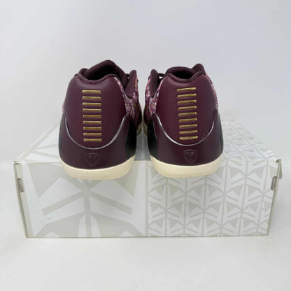 Nike Kobe 9 EM Low Silk sneakers, pre-owned, with all accessories included, shown from the back on a patterned box.