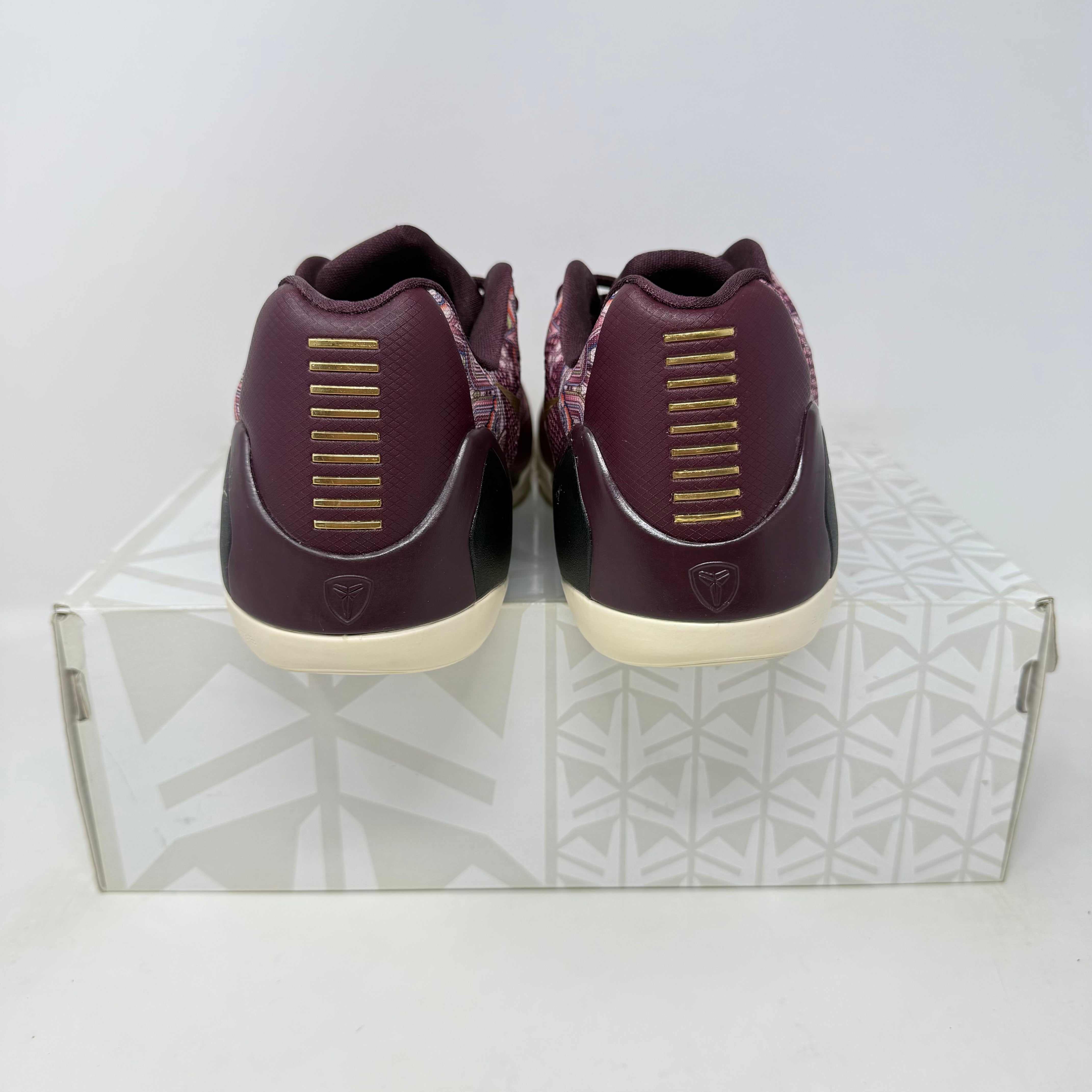 Nike Kobe 9 EM Low Silk sneakers, pre-owned, with all accessories included, shown from the back on a patterned box.