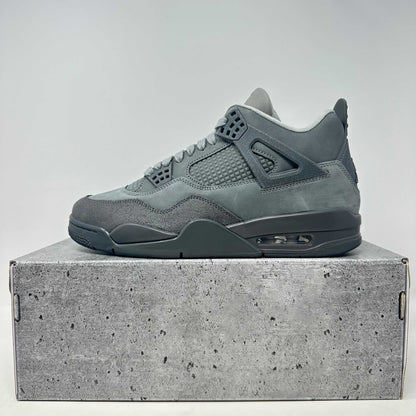 Jordan 4 Retro SE Paris Olympics Wet Cement sneaker on a cement-textured box.