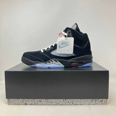 Jordan 5 Retro OG black suede sneaker with metallic silver accents, white laces, and translucent blue sole displayed on box
