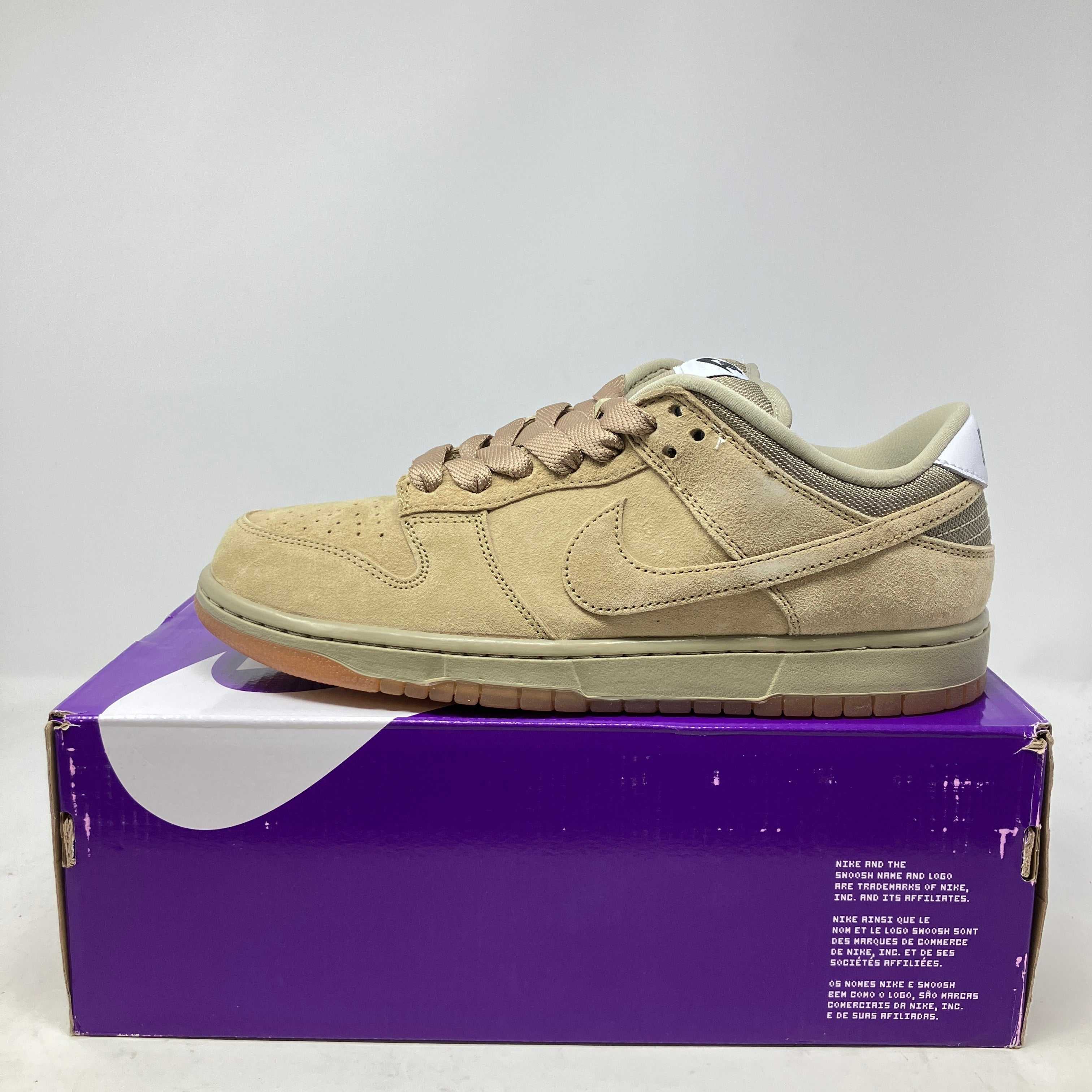 Nike SB Dunk Low Pro B Parachute Beige suede sneaker on purple and white box, brand new with accessories included