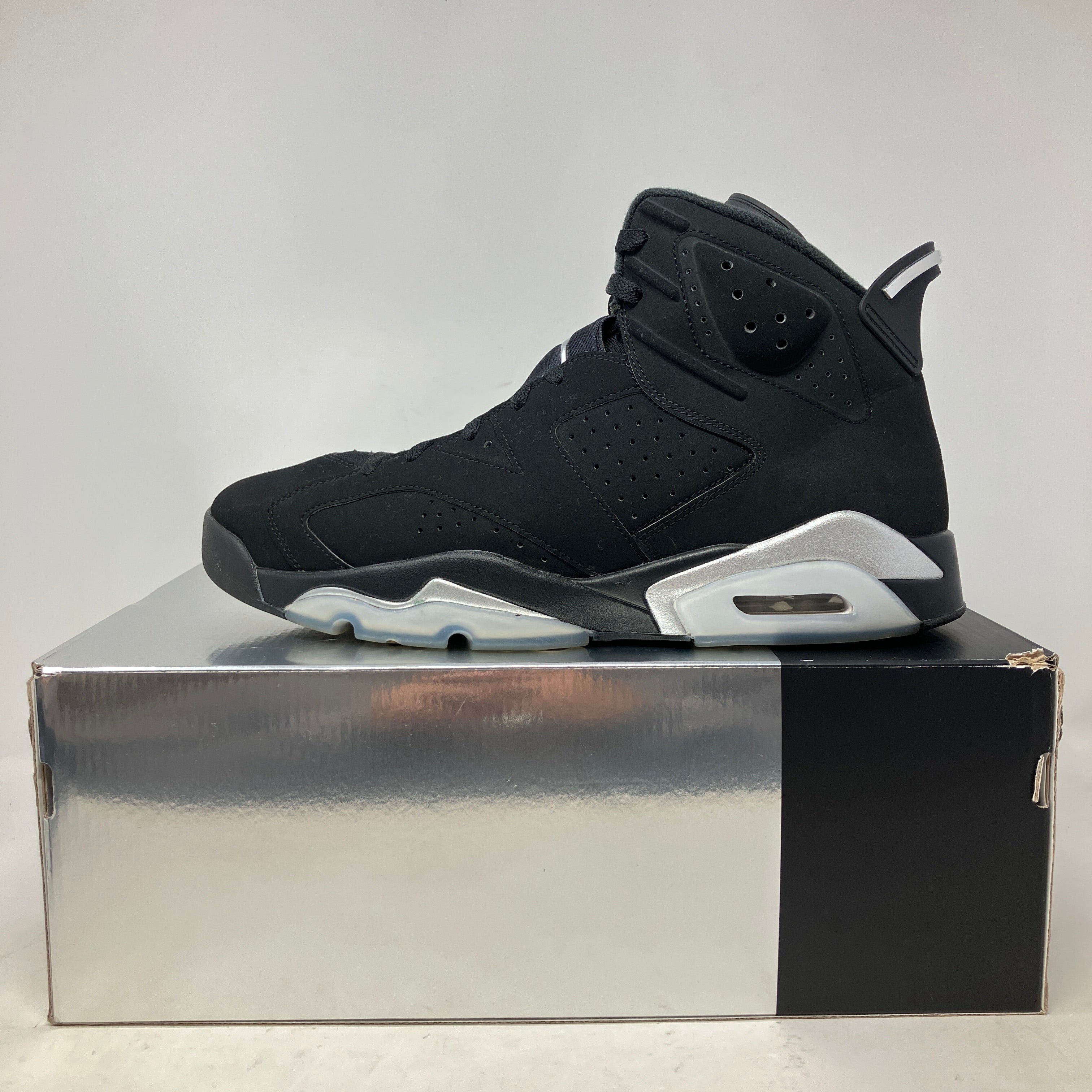 Black Jordan 6 Retro Chrome sneaker displayed on its original silver and black box, pre-owned with all accessories included.
