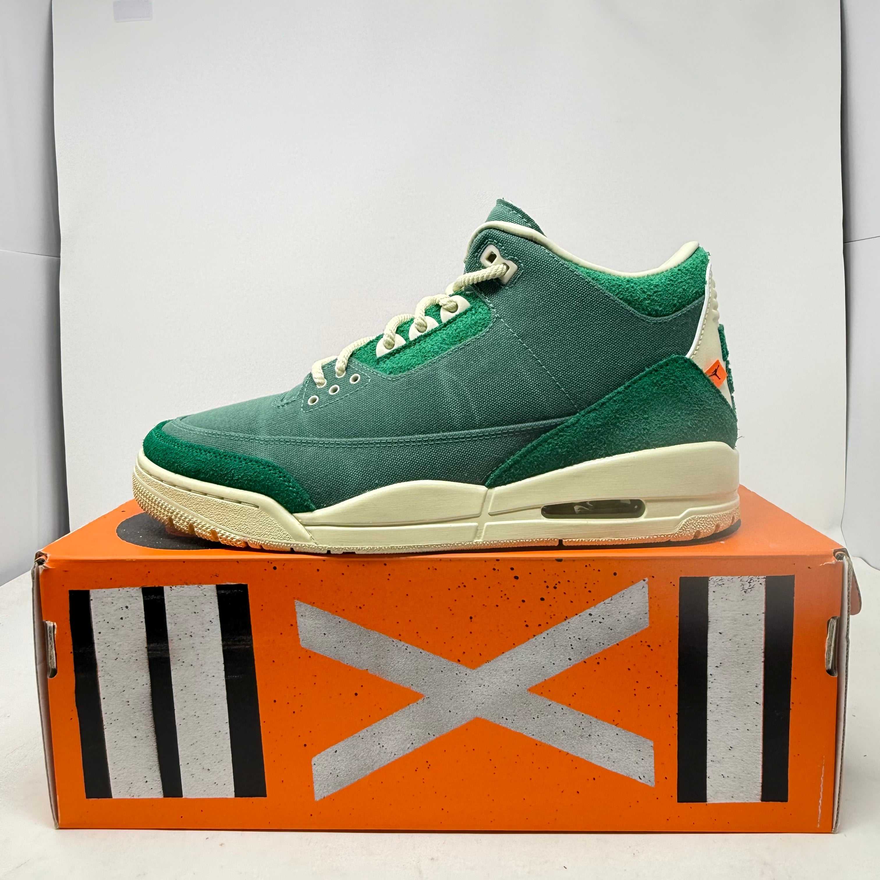 Green Jordan 3 Retro SP Nina Chanel Abney Bicoastal women's sneaker on orange box with black and white markings