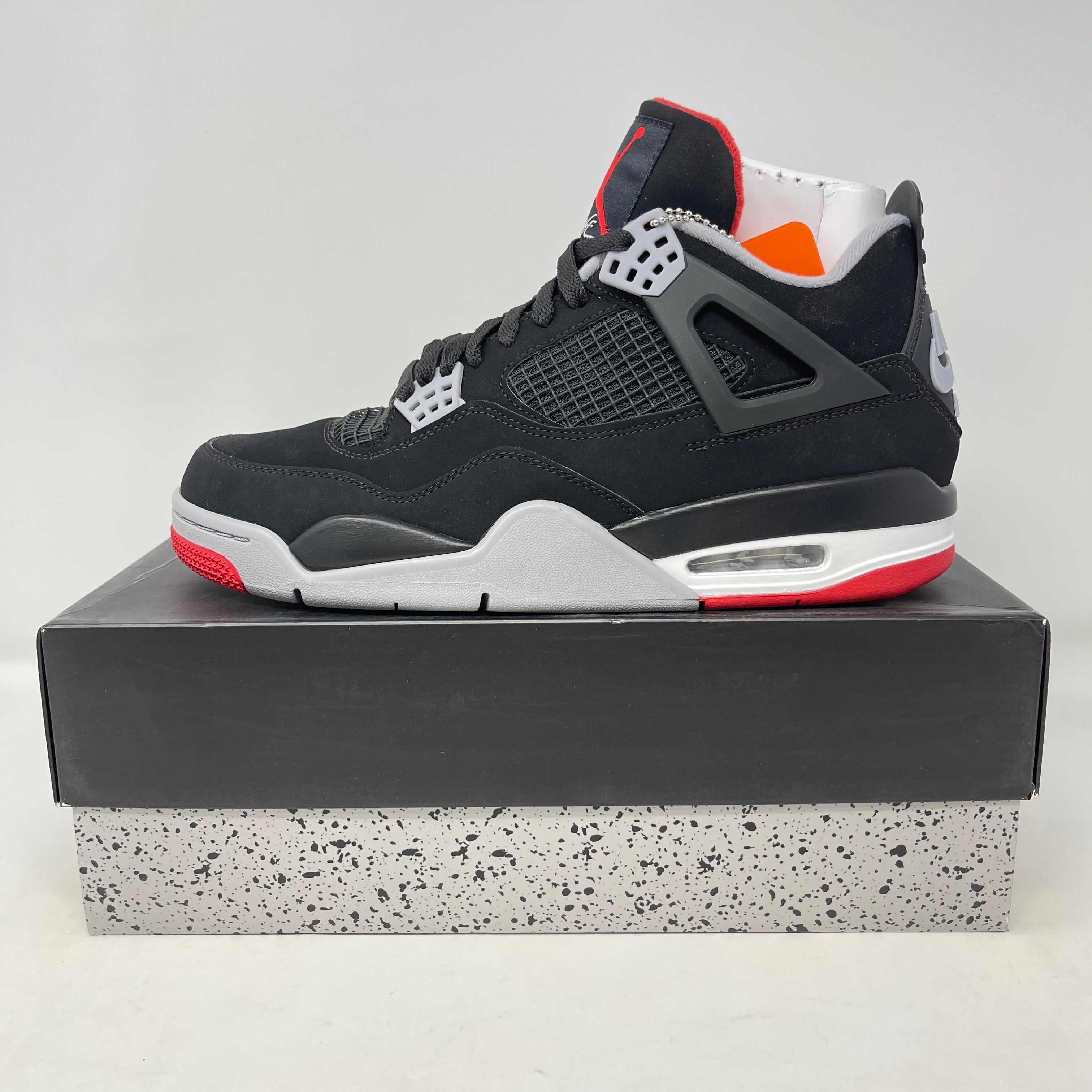 Jordan 4 Retro Bred (2019) sneaker, brand new condition, displayed on a box.