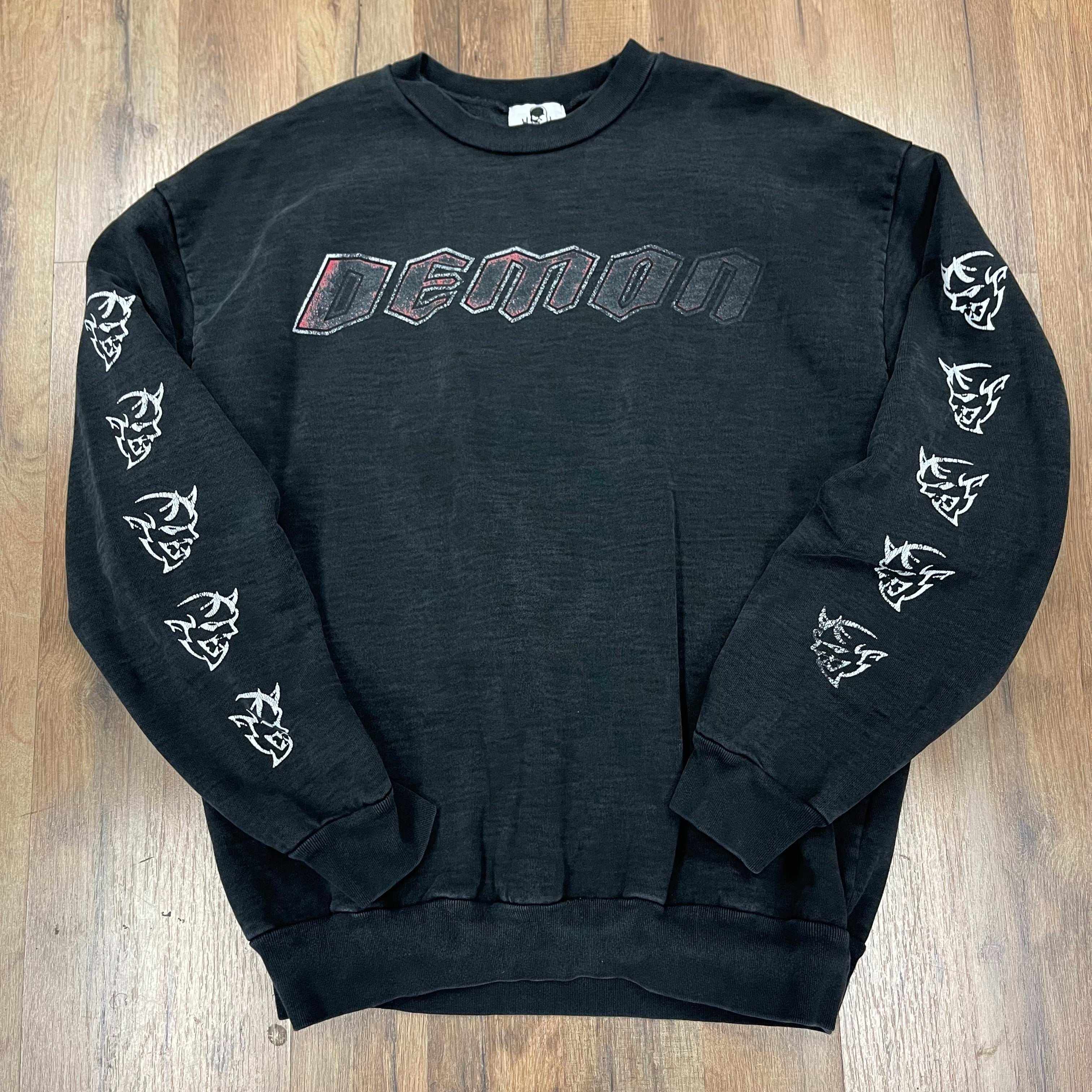 Black Warren Lotas Dodge Demon crewneck sweatshirt with demon head graphics on sleeves and "DEMON" text on front, pre-owned condition