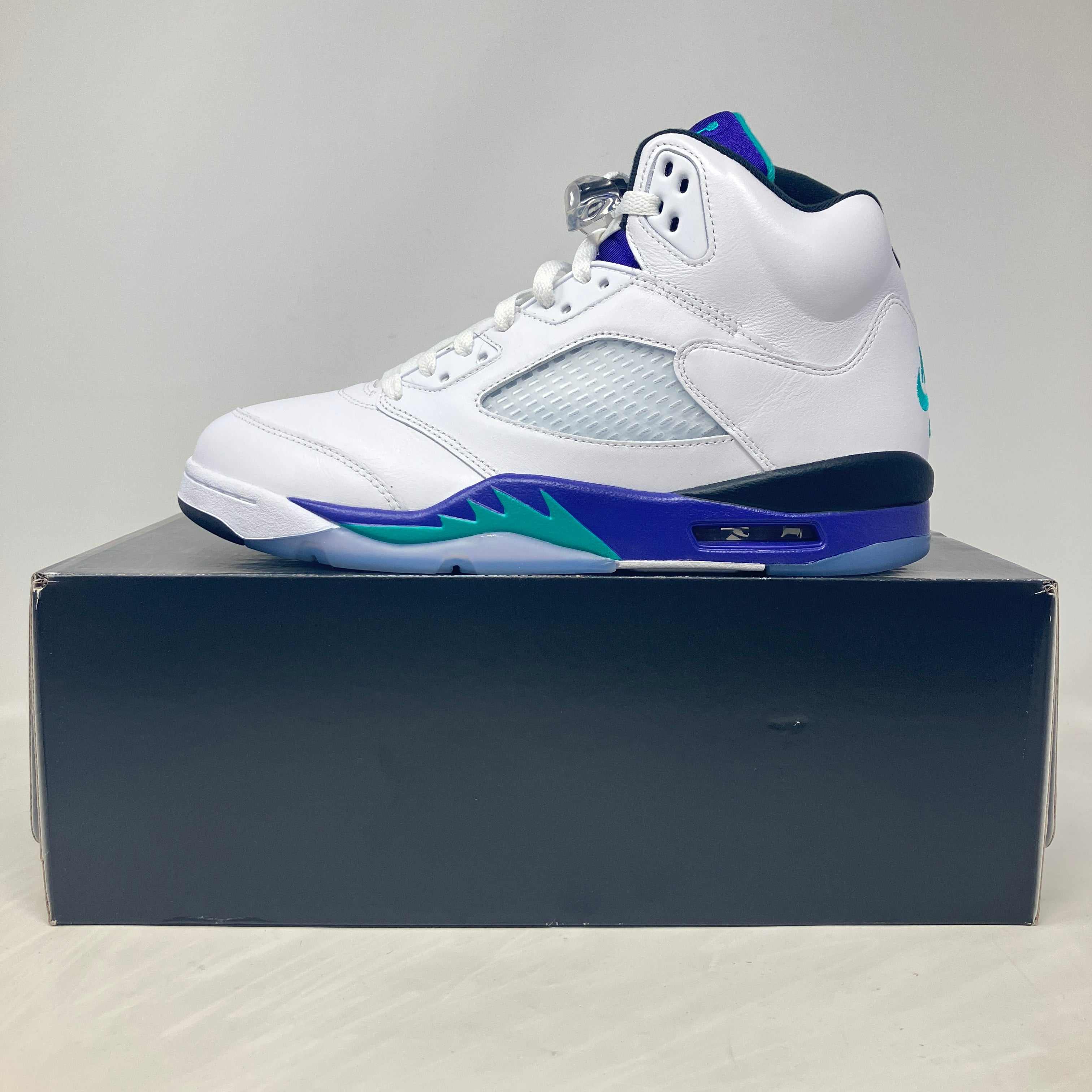 Jordan 5 Retro Grape 2025 sneaker in white, purple, and teal on box, pre-owned with accessories