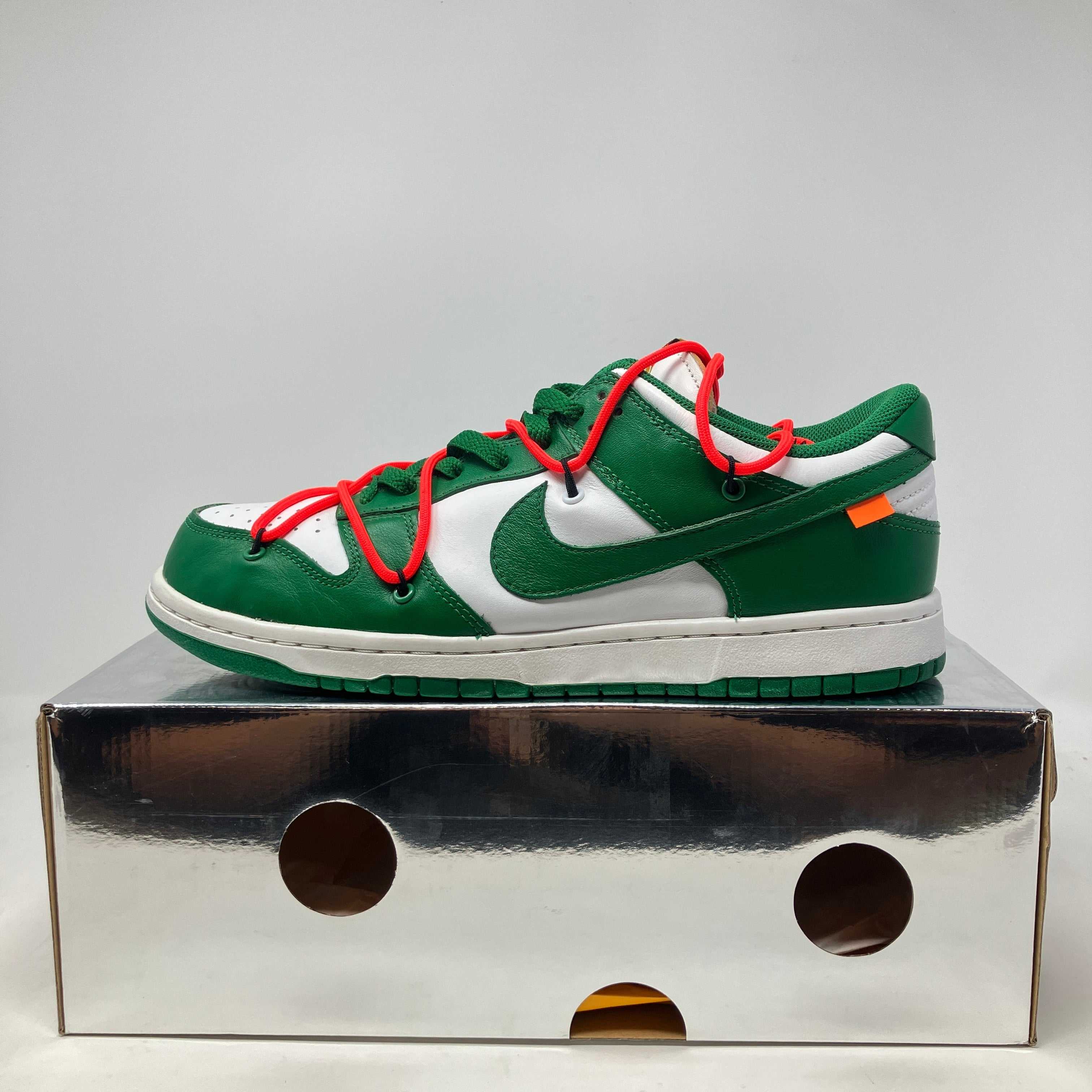 Nike Dunk Low Off-White Pine Green sneaker with red laces on silver shoebox, pre-owned condition with all accessories included