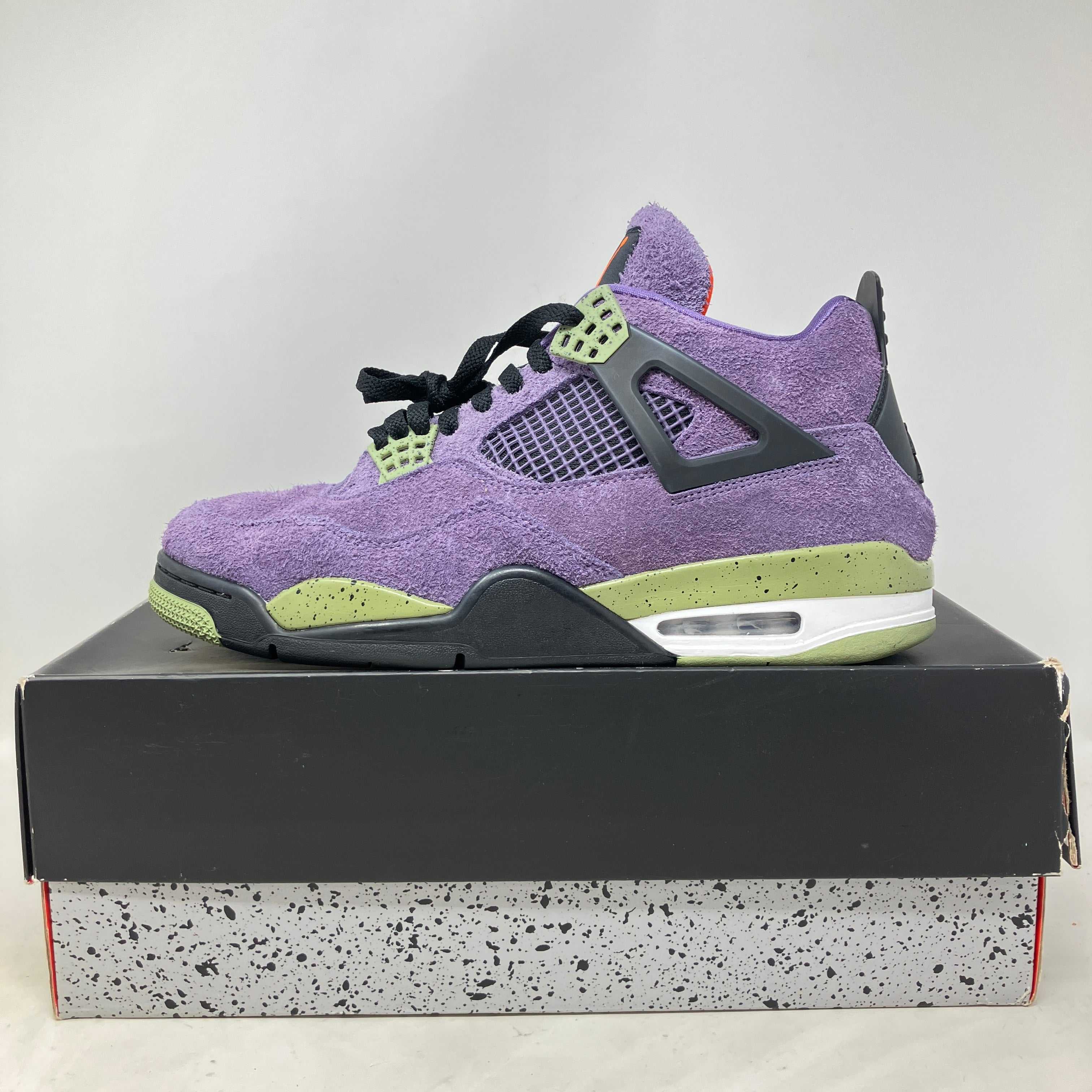 Jordan 4 Retro Canyon Purple women's sneaker in preowned condition on box
