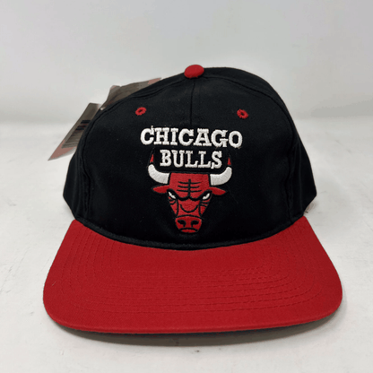 Vintage Chicago Bulls snapback hat with black crown and red brim, featuring embroidered logo and text