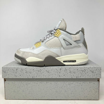 Side view of pre-owned Jordan 4 Retro SE Craft Photon Dust sneaker on speckled gray box with all accessories included