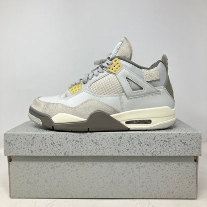 Side view of pre-owned Jordan 4 Retro SE Craft Photon Dust sneaker on speckled gray box with all accessories included