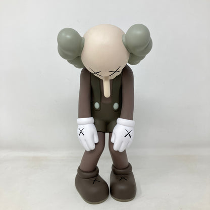 KAWS Small Lie Companion grey vinyl figure standing with head bowed and hands forward, brand new with accessories included.