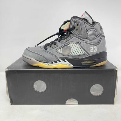 Jordan 5 Retro high-top sneaker in gray suede and mesh, with black laces, translucent panels, yellow accents and 23 detail.