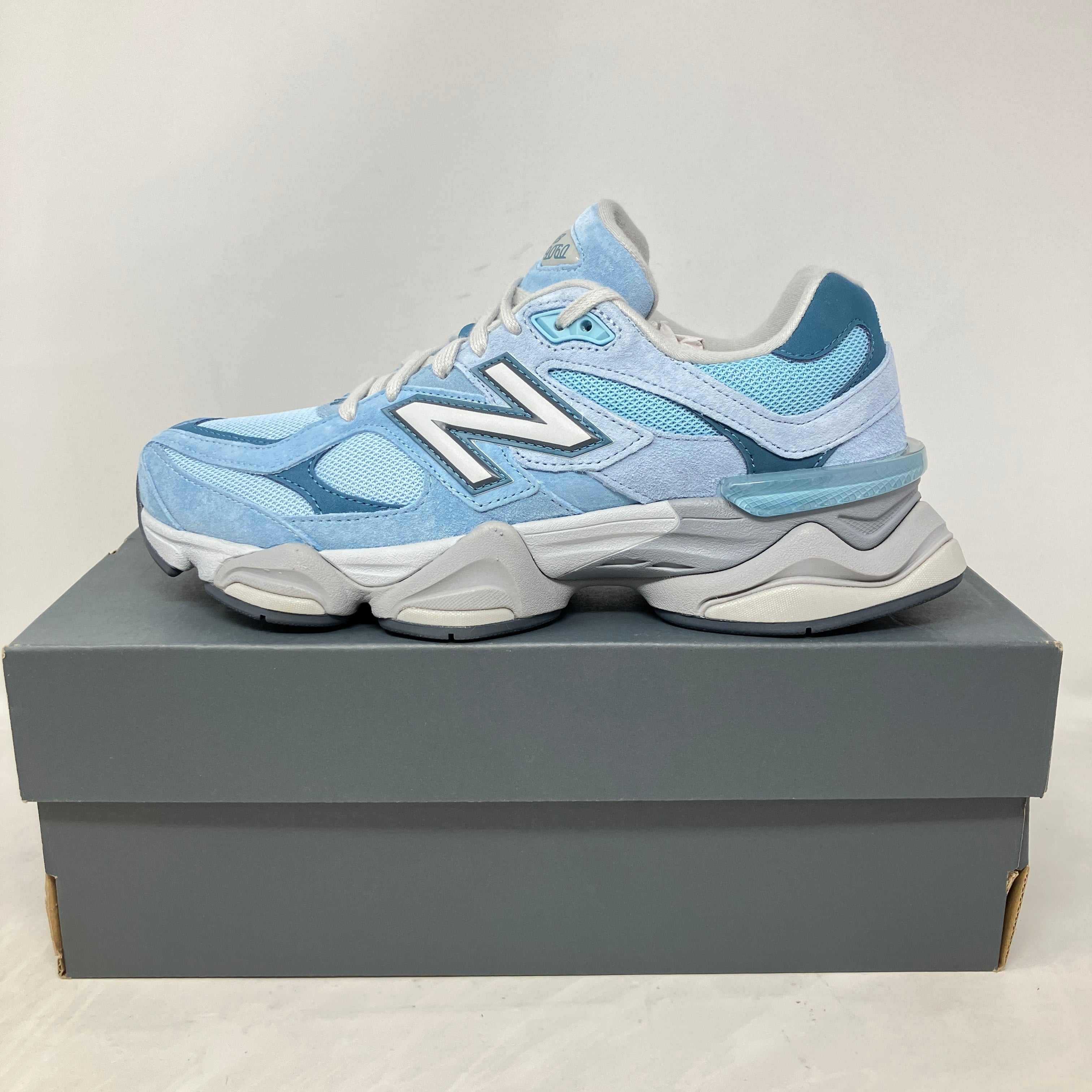 New Balance 9060 Chrome Blue sneaker on grey box, brand new with all accessories included