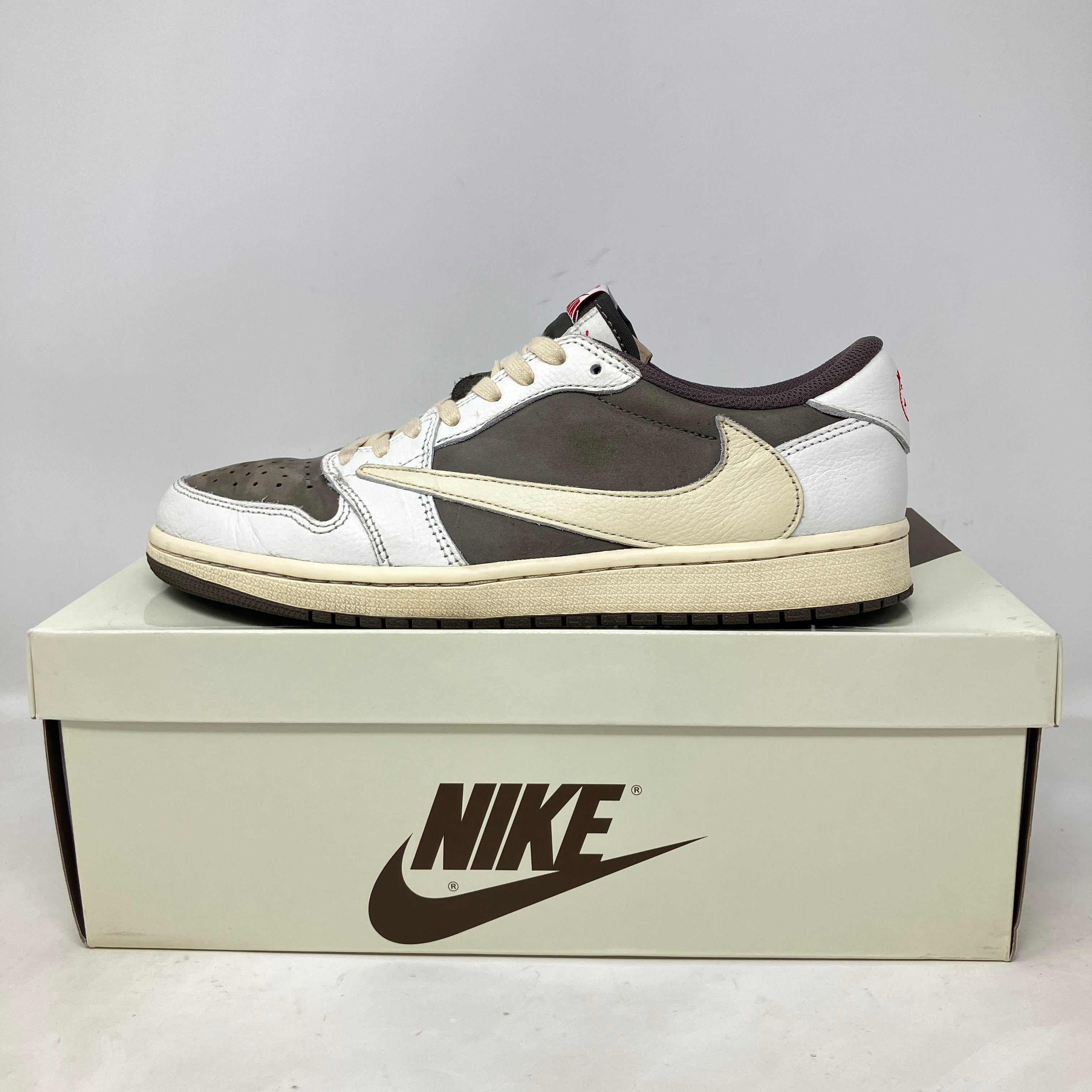 Jordan 1 Retro Low OG Travis Scott Reverse Mocha sneaker on Nike box pre-owned with accessories